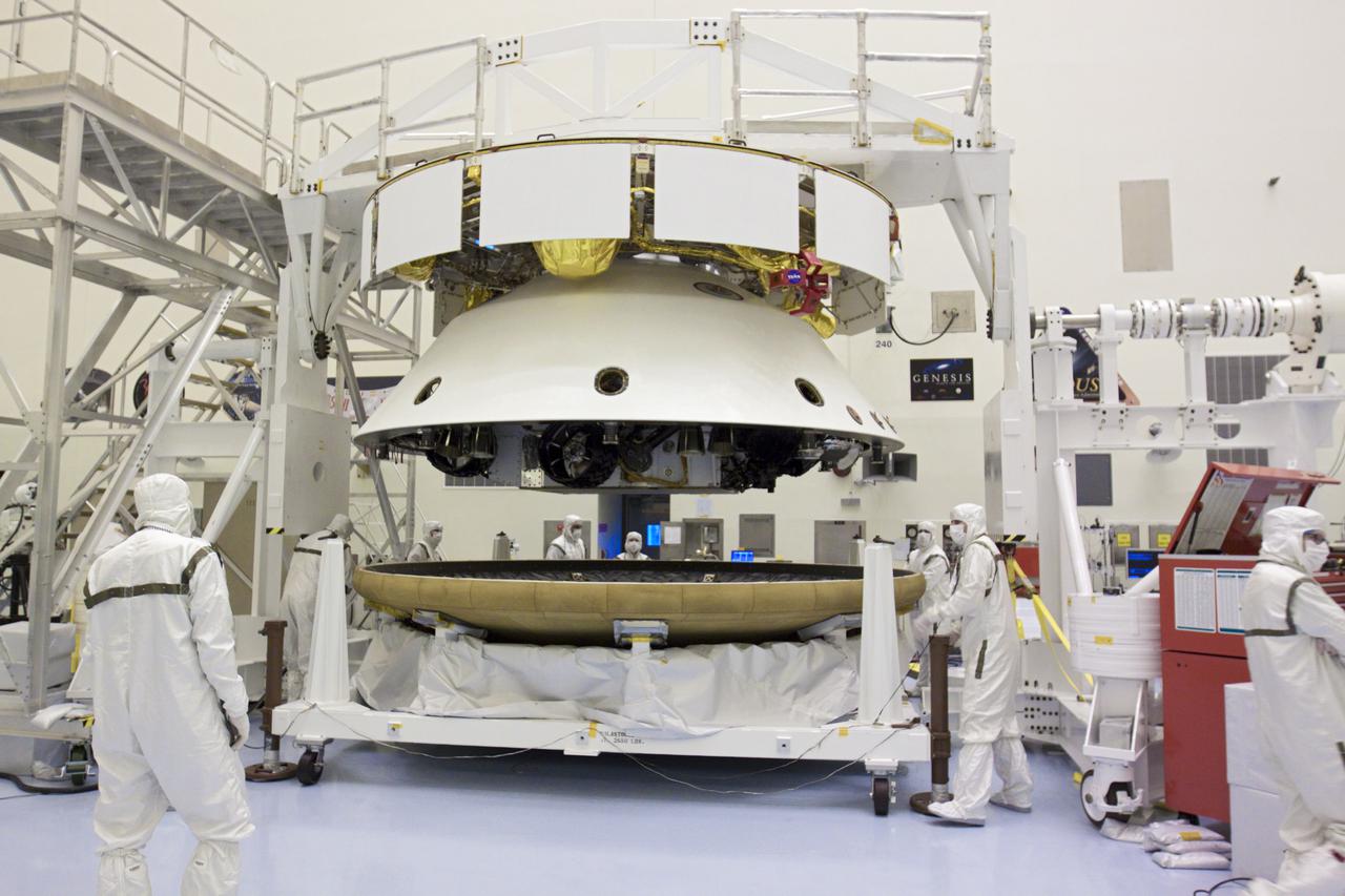 CAPE CANAVERAL, Fla. – In the Payload Hazardous Servicing Facility at NASA’s Kennedy Space Center in Florida, technicians prepare the heat shield for integration with NASA's Mars Science Laboratory (MSL) mission aeroshell, (containing the compact car-sized rover Curiosity). Earlier, the aeroshell was mated to the cruise stage, which provides solar power, thrusters for navigation, and heat exchangers to the rover during its flight from Earth to Mars. The rover Curiosity has 10 science instruments designed to search for evidence on whether Mars has had environments favorable to microbial life, including chemical ingredients for life. The unique rover will use a laser to look inside rocks and release its gasses so that the rover’s spectrometer can analyze and send the data back to Earth. Launch of MSL aboard a United Launch Alliance Atlas V rocket is scheduled for Nov. 25 from Space Launch Complex 41 on Cape Canaveral Air Force Station in Florida. For more information, visit http:__www.nasa.gov_msl. Photo credit: NASA_Glenn Benson