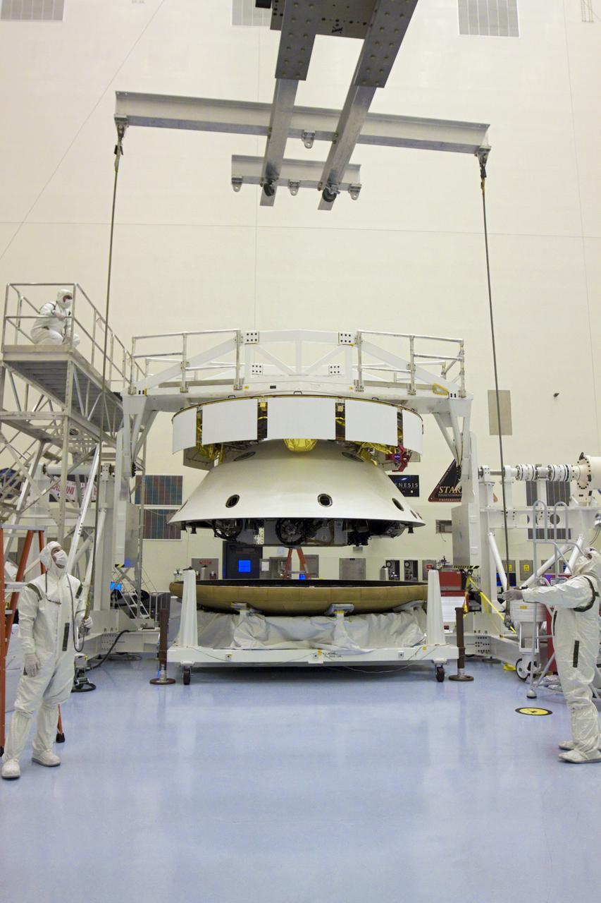 CAPE CANAVERAL, Fla. – In the Payload Hazardous Servicing Facility at NASA’s Kennedy Space Center in Florida, technicians prepare to attach an overhead crane to the heat shield in preparation for integration with NASA's Mars Science Laboratory (MSL) mission aeroshell, (containing the compact car-sized rover Curiosity). Earlier, the aeroshell was mated to the cruise stage, which provides solar power, thrusters for navigation, and heat exchangers to the rover during its flight from Earth to Mars. The rover Curiosity has 10 science instruments designed to search for evidence on whether Mars has had environments favorable to microbial life, including chemical ingredients for life. The unique rover will use a laser to look inside rocks and release its gasses so that the rover’s spectrometer can analyze and send the data back to Earth. Launch of MSL aboard a United Launch Alliance Atlas V rocket is scheduled for Nov. 25 from Space Launch Complex 41 on Cape Canaveral Air Force Station in Florida. For more information, visit http:__www.nasa.gov_msl. Photo credit: NASA_Glenn Benson