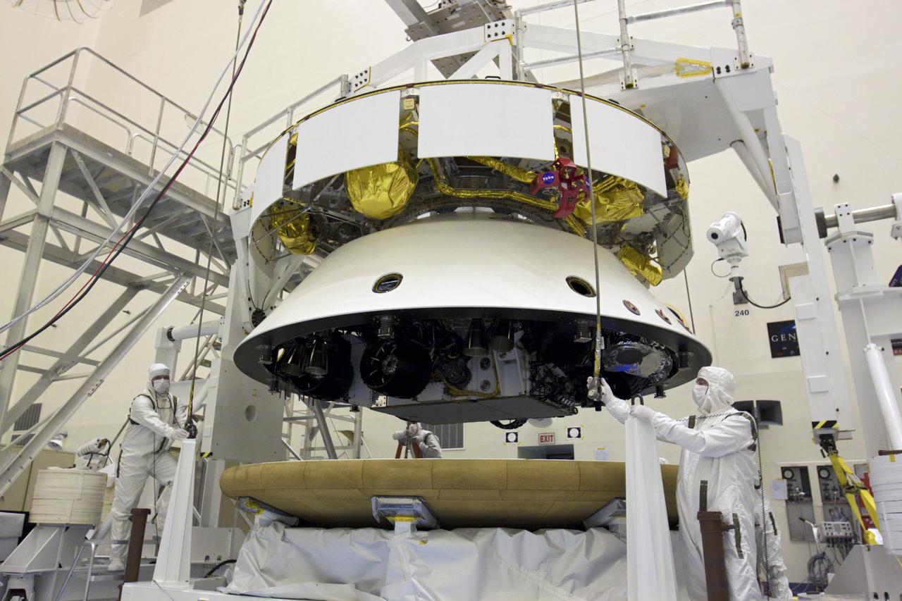 CAPE CANAVERAL, Fla. – In the Payload Hazardous Servicing Facility at NASA’s Kennedy Space Center in Florida, technicians attach an overhead crane to the heat shield in preparation for integration with NASA's Mars Science Laboratory (MSL) mission aeroshell, (containing the compact car-sized rover Curiosity). Earlier, the aeroshell was mated to the cruise stage, which provides solar power, thrusters for navigation, and heat exchangers to the rover during its flight from Earth to Mars. The rover Curiosity has 10 science instruments designed to search for evidence on whether Mars has had environments favorable to microbial life, including chemical ingredients for life. The unique rover will use a laser to look inside rocks and release its gasses so that the rover’s spectrometer can analyze and send the data back to Earth. Launch of MSL aboard a United Launch Alliance Atlas V rocket is scheduled for Nov. 25 from Space Launch Complex 41 on Cape Canaveral Air Force Station in Florida. For more information, visit http:__www.nasa.gov_msl. Photo credit: NASA_Glenn Benson