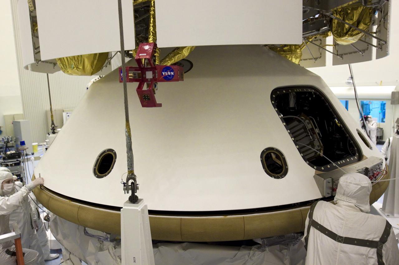 CAPE CANAVERAL, Fla. – In the Payload Hazardous Servicing Facility at NASA’s Kennedy Space Center in Florida, technicians inspect the alignment of the heat shield as an overhead crane lifts it for integration with NASA's Mars Science Laboratory (MSL) mission aeroshell, (containing the compact car-sized rover Curiosity). Earlier, the aeroshell was mated to the cruise stage, which provides solar power, thrusters for navigation, and heat exchangers to the rover during its flight from Earth to Mars. The rover Curiosity has 10 science instruments designed to search for evidence on whether Mars has had environments favorable to microbial life, including chemical ingredients for life. The unique rover will use a laser to look inside rocks and release its gasses so that the rover’s spectrometer can analyze and send the data back to Earth. Launch of MSL aboard a United Launch Alliance Atlas V rocket is scheduled for Nov. 25 from Space Launch Complex 41 on Cape Canaveral Air Force Station in Florida. For more information, visit http:__www.nasa.gov_msl. Photo credit: NASA_Glenn Benson