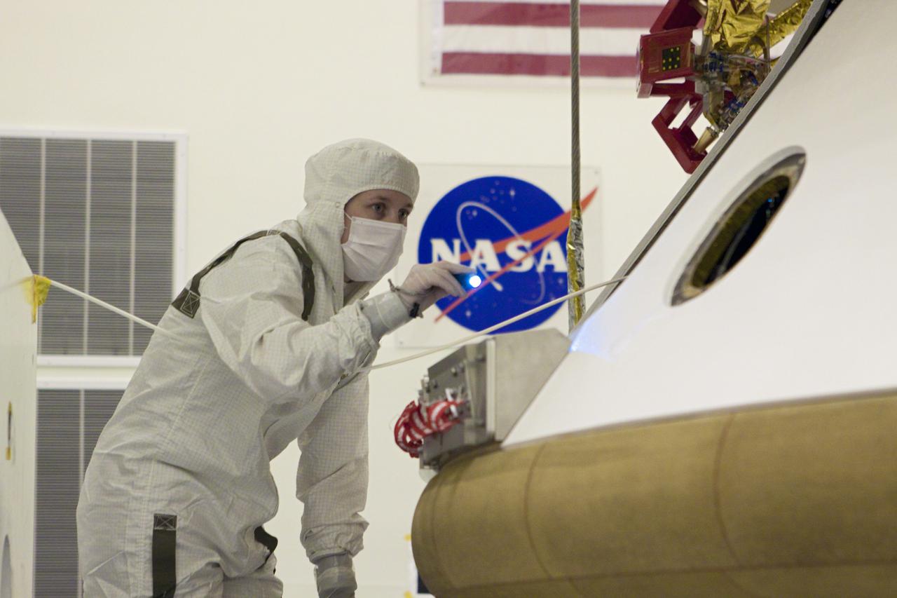 CAPE CANAVERAL, Fla. – In the Payload Hazardous Servicing Facility at NASA’s Kennedy Space Center in Florida, a technician inspects the alignment of the heat shield after integration with NASA's Mars Science Laboratory (MSL) mission aeroshell, (containing the compact car-sized rover Curiosity). Earlier, the aeroshell was mated to the cruise stage, which provides solar power, thrusters for navigation, and heat exchangers to the rover during its flight from Earth to Mars. The rover Curiosity has 10 science instruments designed to search for evidence on whether Mars has had environments favorable to microbial life, including chemical ingredients for life. The unique rover will use a laser to look inside rocks and release its gasses so that the rover’s spectrometer can analyze and send the data back to Earth. Launch of MSL aboard a United Launch Alliance Atlas V rocket is scheduled for Nov. 25 from Space Launch Complex 41 on Cape Canaveral Air Force Station in Florida. For more information, visit http:__www.nasa.gov_msl. Photo credit: NASA_Glenn Benson