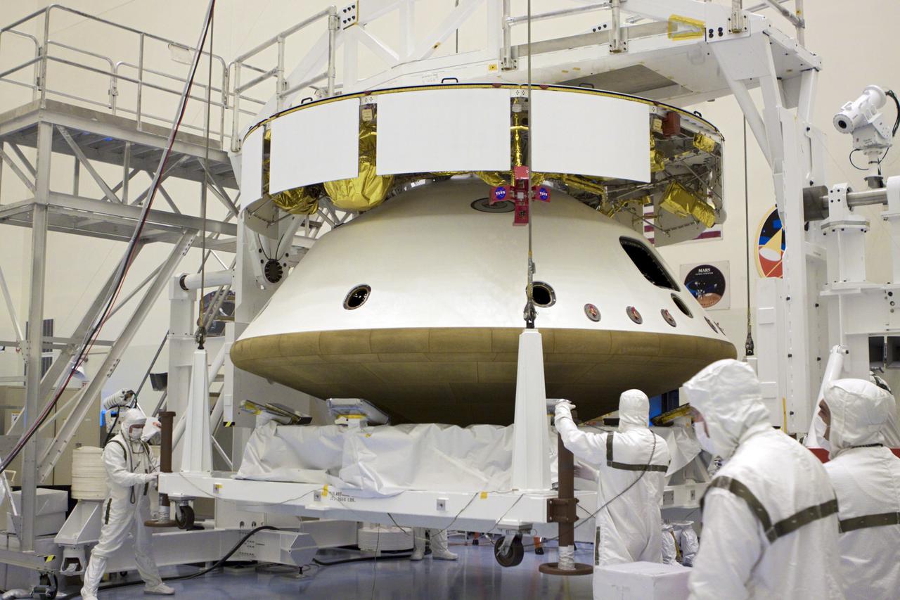 CAPE CANAVERAL, Fla. – In the Payload Hazardous Servicing Facility at NASA’s Kennedy Space Center in Florida, using an overhead crane, technicians lower a carrier which housed the heat shield, after integration with NASA's Mars Science Laboratory (MSL) mission aeroshell, (containing the compact car-sized rover Curiosity). Earlier, the aeroshell was mated to the cruise stage, which provides solar power, thrusters for navigation, and heat exchangers to the rover during its flight from Earth to Mars. The rover Curiosity has 10 science instruments designed to search for evidence on whether Mars has had environments favorable to microbial life, including chemical ingredients for life. The unique rover will use a laser to look inside rocks and release its gasses so that the rover’s spectrometer can analyze and send the data back to Earth. Launch of MSL aboard a United Launch Alliance Atlas V rocket is scheduled for Nov. 25 from Space Launch Complex 41 on Cape Canaveral Air Force Station in Florida. For more information, visit http:__www.nasa.gov_msl. Photo credit: NASA_Glenn Benson