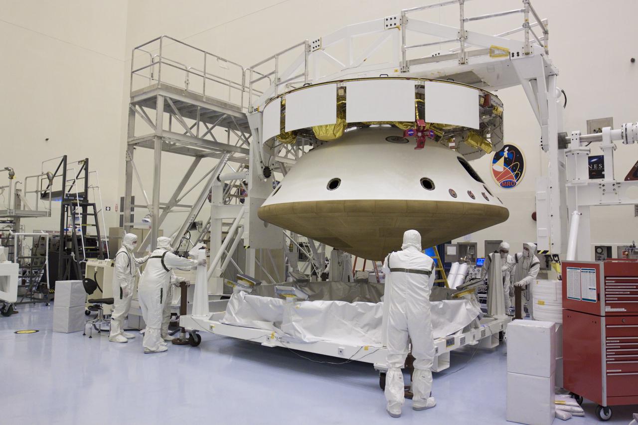 CAPE CANAVERAL, Fla. – In the Payload Hazardous Servicing Facility at NASA’s Kennedy Space Center in Florida, technicians move the heat shield carrier away from under the heat shield after integration with NASA's Mars Science Laboratory (MSL) mission aeroshell, (containing the compact car-sized rover Curiosity). Earlier, the aeroshell was mated to the cruise stage, which provides solar power, thrusters for navigation, and heat exchangers to the rover during its flight from Earth to Mars. The rover Curiosity has 10 science instruments designed to search for evidence on whether Mars has had environments favorable to microbial life, including chemical ingredients for life. The unique rover will use a laser to look inside rocks and release its gasses so that the rover’s spectrometer can analyze and send the data back to Earth. Launch of MSL aboard a United Launch Alliance Atlas V rocket is scheduled for Nov. 25 from Space Launch Complex 41 on Cape Canaveral Air Force Station in Florida. For more information, visit http:__www.nasa.gov_msl. Photo credit: NASA_Glenn Benson