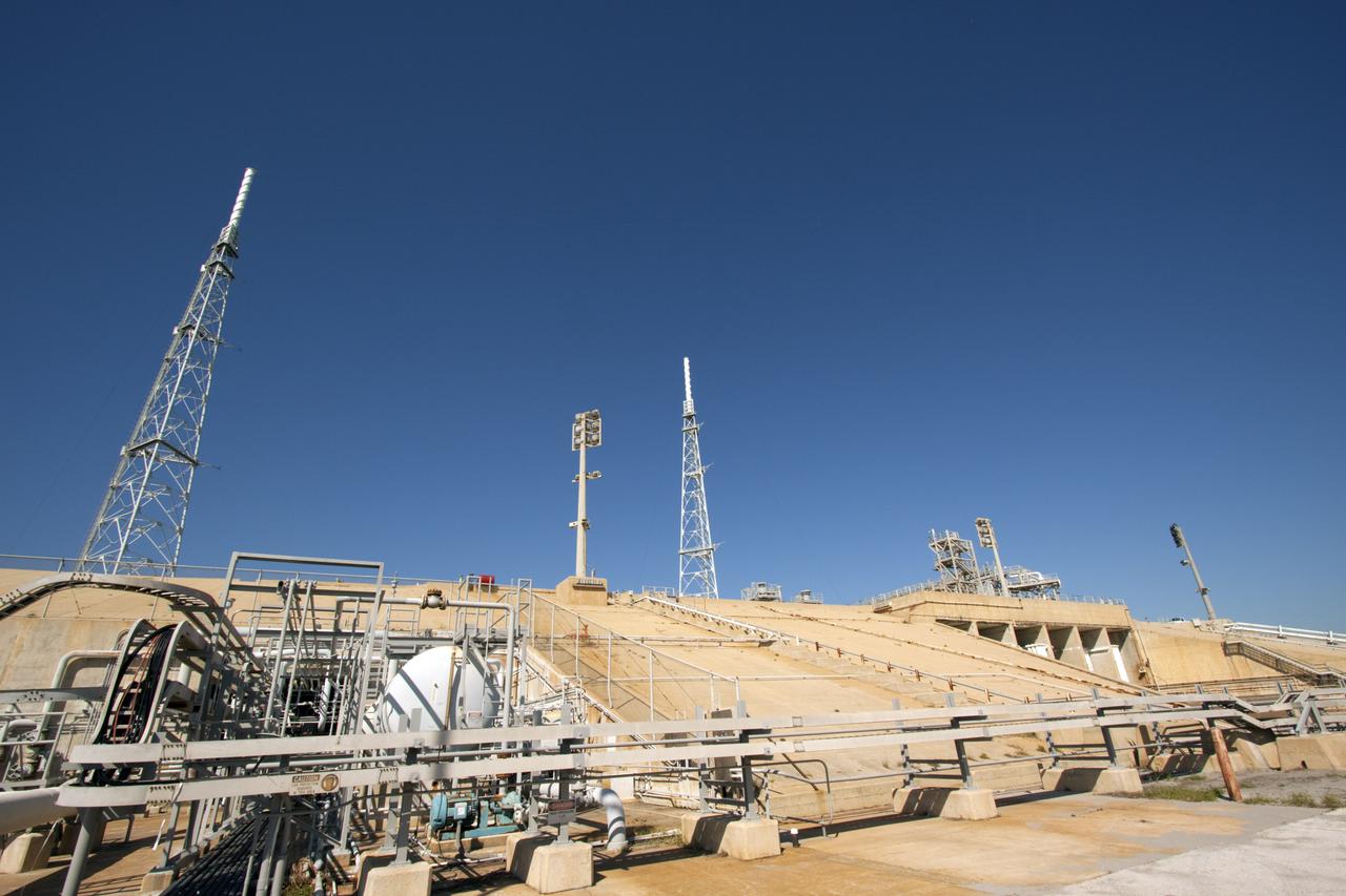 CAPE CANAVERAL, Fla. – Launch Pad 39B at NASA's Kennedy Space Center in Florida has been refurbished extensively and work is continuing to modify the pad to support a variety of launch vehicles in the future. Designers are looking for new, flame and vibration-resistant materials to line the trench. To help in the search, a team of mechanical engineering students at Louisiana State University are to build a scaled-down version of the flame trench that Kennedy's scientists can use to try out sample materials for the trench. If the samples work in the lab, they can be tried out in the real flame trenches at Launch Pad 39A and 39B. Photo credit: NASA_Jim Grossmann