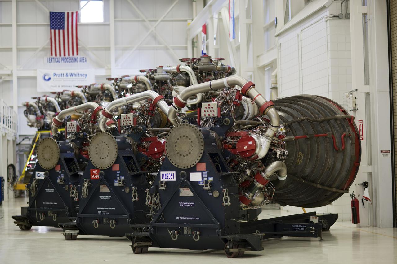 CAPE CANAVERAL, Fla. – At NASA’s Kennedy Space Center in Florida, three Pratt Whitney Rocketdyne space shuttle main engines (SSMEs) sit on stands inside the Engine Shop, with six more engines lined up behind them. For the first time, all 15 main engines are in the Engine Shop at the same time. They are being prepared for shipment to NASA's Stennis Space Center in Mississippi for storage following the completion of the Space Shuttle Program. The engines are being repurposed for use on NASA’s Space Launch System heavy lift rocket. Photo credit: NASA_Dimitri Gerondidakis