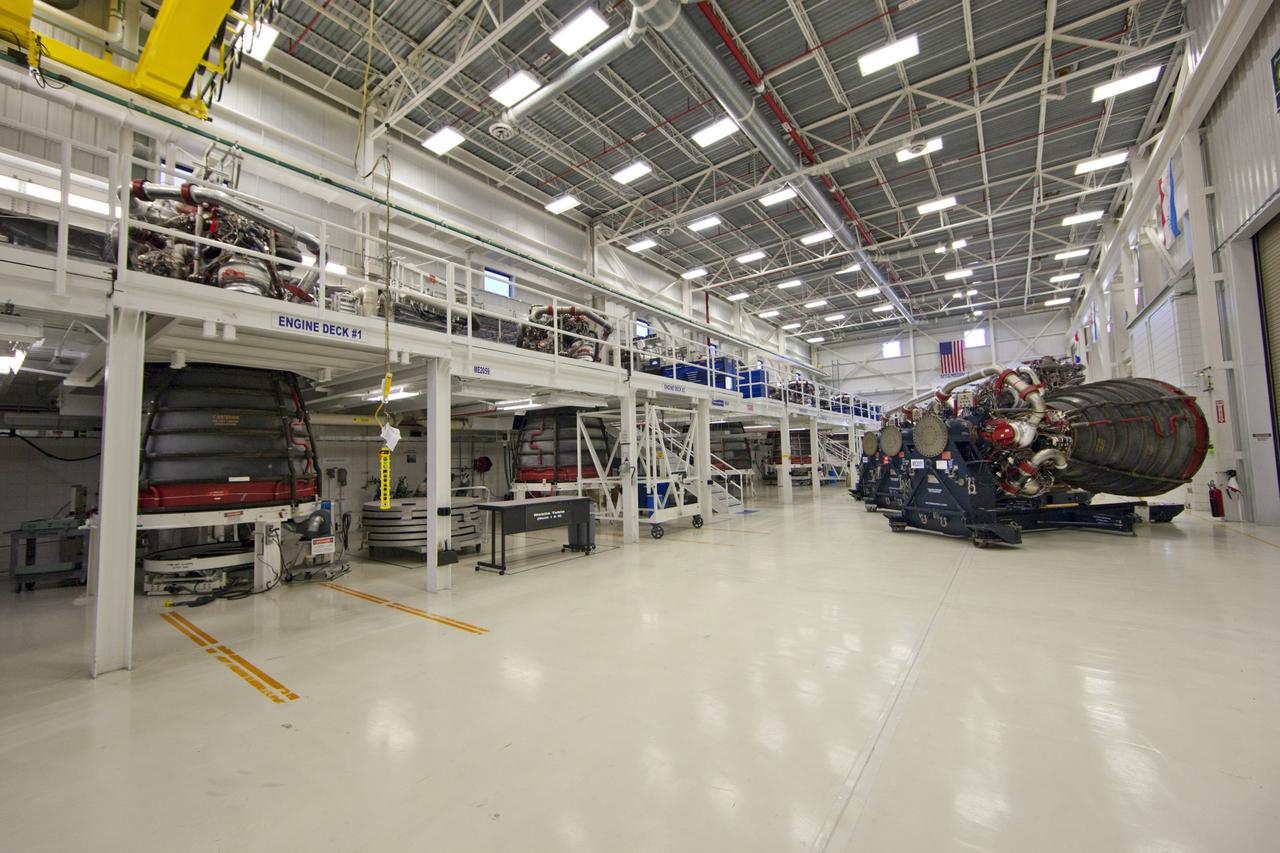 CAPE CANAVERAL, Fla. – At NASA’s Kennedy Space Center in Florida, all six Pratt Whitney Rocketdyne space shuttle main engines (SSMEs) from space shuttle Endeavour's STS-134 and space shuttle Atlantis' STS-135 missions sit in test cells inside the Engine Shop. To the right are three more main engines on platforms.   For the first time, all 15 main engines are in the Engine Shop at the same time. They are being prepared for shipment to NASA's Stennis Space Center in Mississippi for storage following the completion of the Space Shuttle Program. The engines are being repurposed for use on NASA’s Space Launch System heavy lift rocket. Photo credit: NASA_Dimitri Gerondidakis