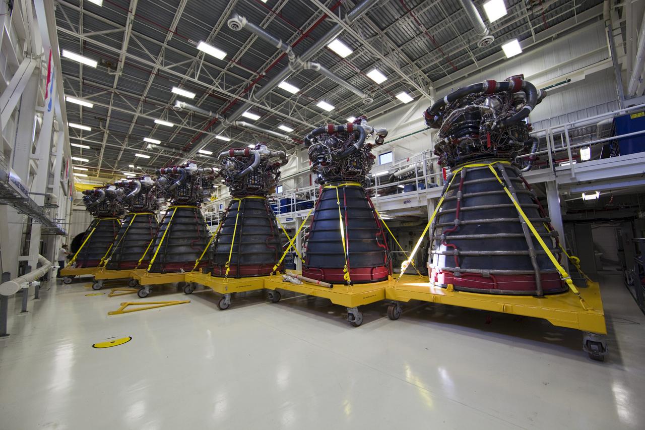 CAPE CANAVERAL, Fla. – Lined up in a row, six Pratt Whitney Rocketdyne space shuttle main engines (SSMEs) sit on stands inside the Engine Shop at NASA’s Kennedy Space Center in Florida. For the first time, all 15 main engines are in the Engine Shop at the same time. They are being prepared for shipment to NASA's Stennis Space Center in Mississippi for storage following the completion of the Space Shuttle Program. The engines are being repurposed for use on NASA’s Space Launch System heavy lift rocket. Photo credit: NASA_Dimitri Gerondidakis