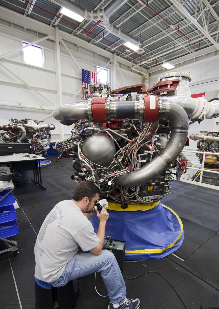CAPE CANAVERAL, Fla. – Inside the Engine Shop at NASA’s Kennedy Space Center in Florida, a technician performs a boroscope test on a high pressure oxidizer pump on one of the Pratt Whitney Rocketdyne space shuttle main engines (SSMEs) positioned in a test cell.   For the first time, all 15 main engines are in the Engine Shop at the same time. They are being prepared for shipment to NASA's Stennis Space Center in Mississippi for storage following the completion of the Space Shuttle Program. The engines are being repurposed for use on NASA’s Space Launch System heavy lift rocket. Photo credit: NASA_Dimitri Gerondidakis