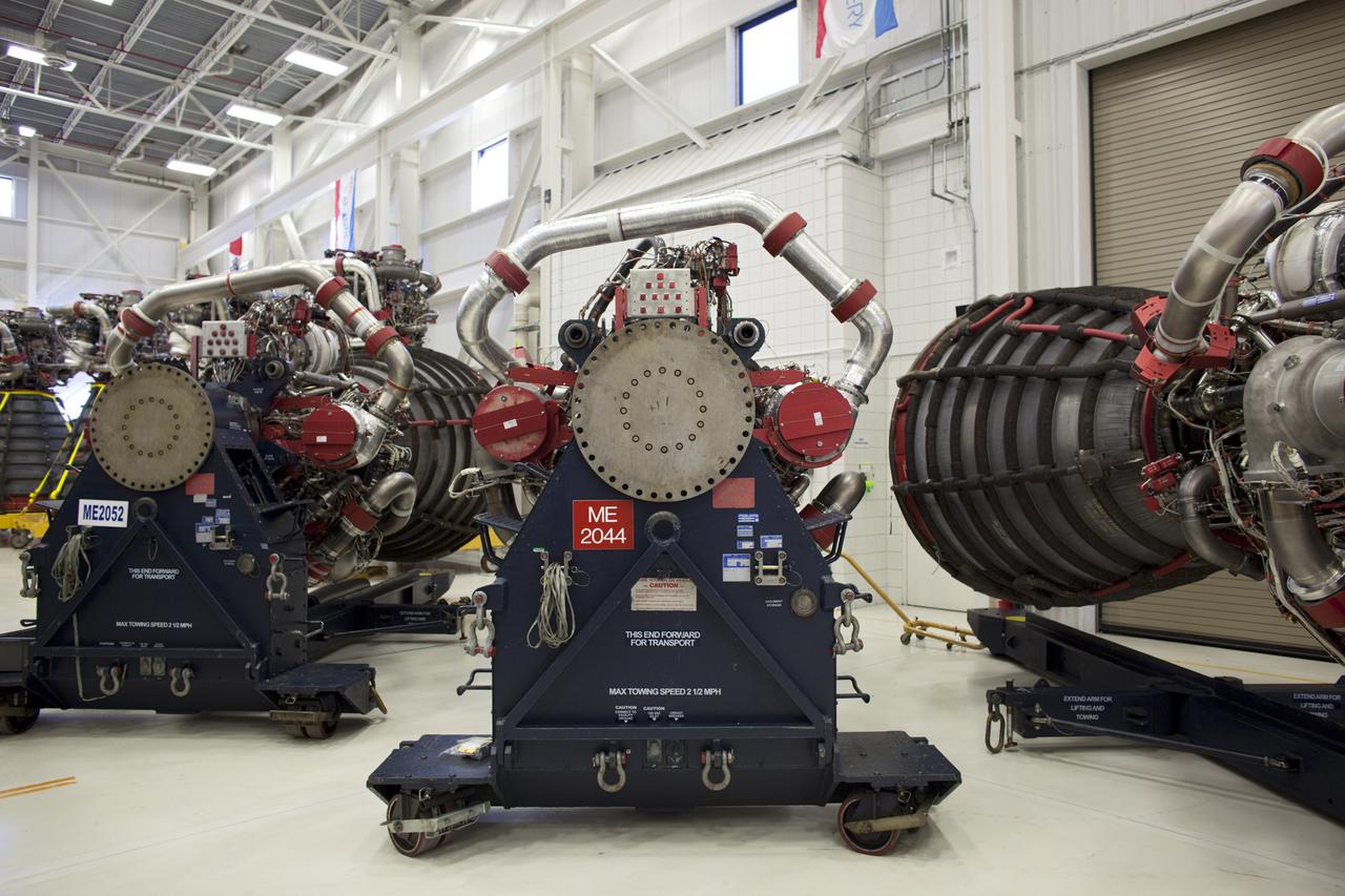 CAPE CANAVERAL, Fla. – Several Pratt Whitney Rocketdyne space shuttle main engines (SSMEs) sit on stands inside the Engine Shop at NASA’s Kennedy Space Center in Florida. For the first time, all 15 main engines are in the Engine Shop at the same time. They are being prepared for shipment to NASA's Stennis Space Center in Mississippi for storage following the completion of the Space Shuttle Program. The engines are being repurposed for use on NASA’s Space Launch System heavy lift rocket. Photo credit: NASA_Dimitri Gerondidakis
