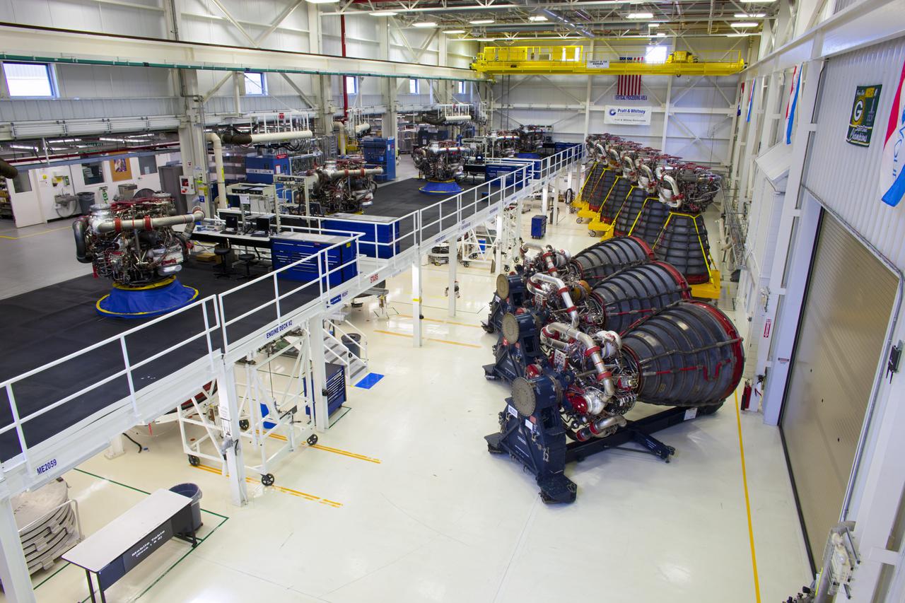 CAPE CANAVERAL, Fla. – At NASA’s Kennedy Space Center in Florida, three Pratt Whitney Rocketdyne space shuttle main engines (SSMEs) sit on stands inside the Engine Shop, with six more engines lined up behind them. For the first time, all 15 main engines are in the Engine Shop at the same time. They are being prepared for shipment to NASA's Stennis Space Center in Mississippi for storage following the completion of the Space Shuttle Program. The engines are being repurposed for use on NASA’s Space Launch System heavy lift rocket. Photo credit: NASA_Dimitri Gerondidakis