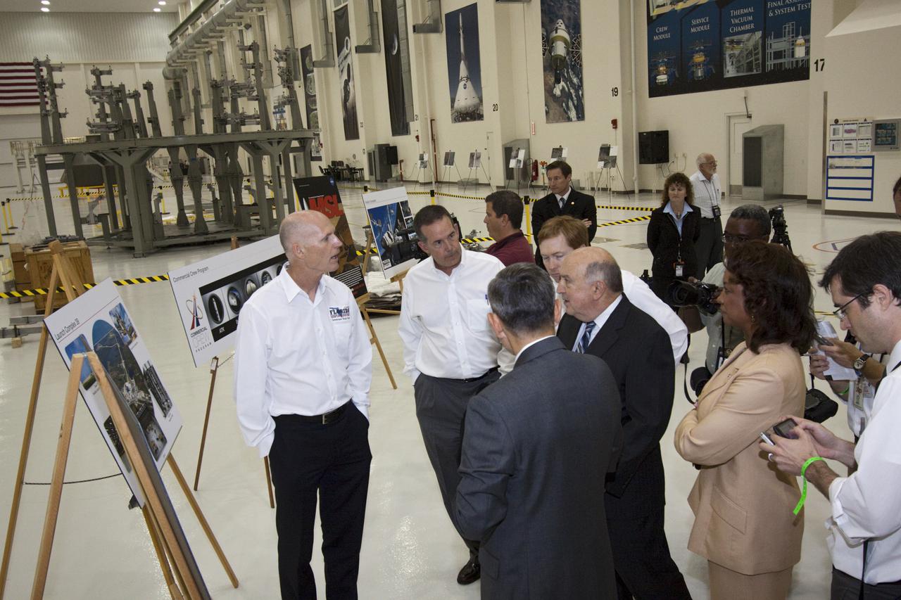 CAPE CANAVERAL, Fla. – Florida Gov. Rick Scott (left) tours the Operations and Checkout Building at NASA's Kennedy Space Center in Florida. He is being briefed on the processing of the Orion Multi-Purpose Crew Vehicle. With his back to the camera is Robert Cabana, Kennedy Space Center director. To Cabana’s right is Florida Lt. Gov. Jennifer Carroll, chairwoman of Space Florida. To the governor’s left is Jeff Atwater, Florida chief financial officer.  The governor and other state officials were at Kennedy for a Florida cabinet meeting and a space industry roundtable at the Kennedy Space Center Visitor Complex’s Debus Conference Center. They also toured selected facilities around the center. Photo credit: NASA_Jim Grossmann