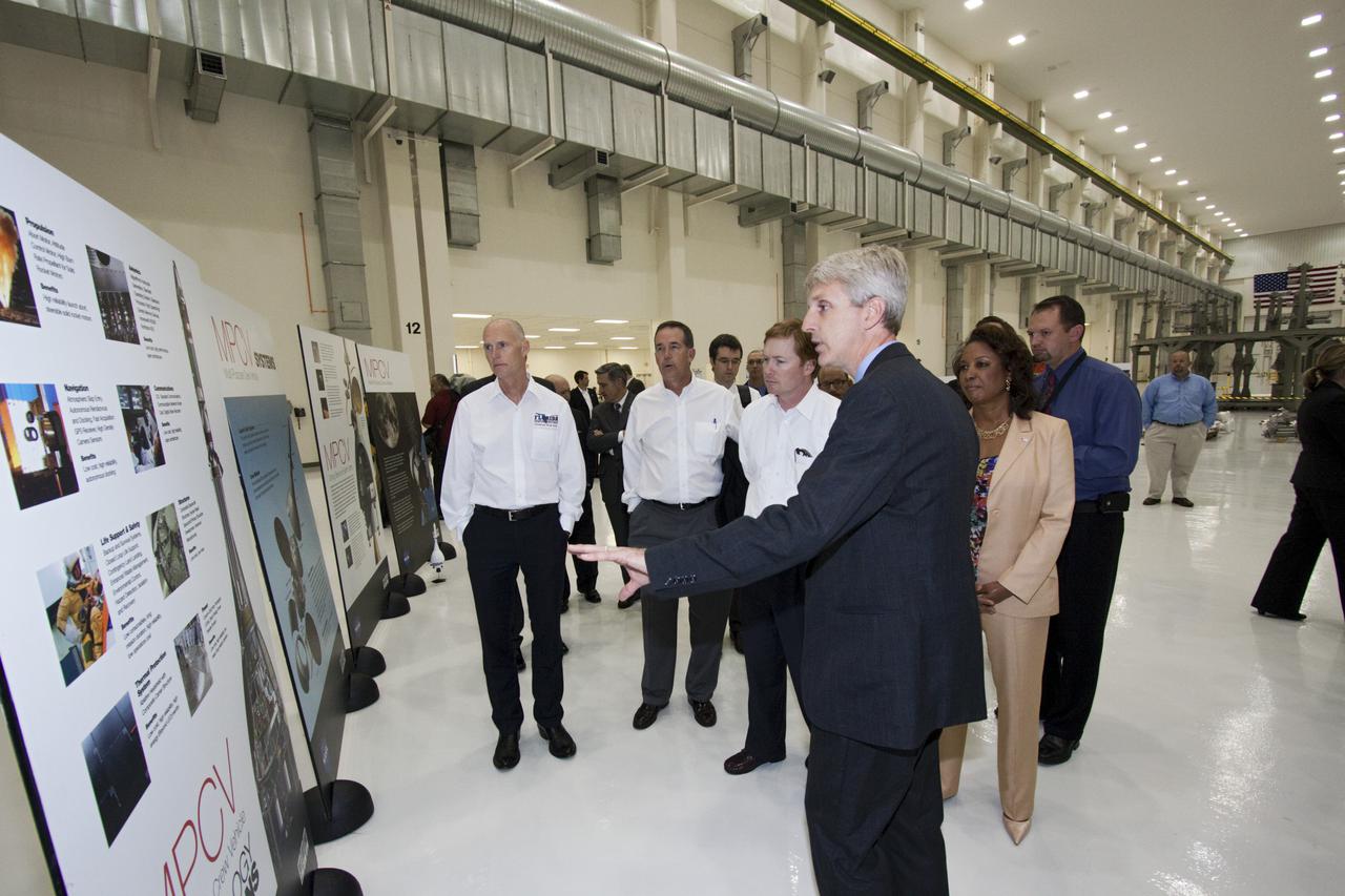CAPE CANAVERAL, Fla. – In the Operations and Checkout Building at NASA's Kennedy Space Center in Florida, NASA’s Orion Production Manager Scott Wilson, (center), briefs Florida Gov. Rick Scott, (left), and Florida Lt. Gov. Jennifer Carroll, chairwoman of Space Florida, (right), on the processing of the Orion Multi-Purpose Crew Vehicle which will be processed in the facility. Also listening are Jeff Atwater, Florida chief financial officer and Adam Putnam, Florida agriculture commissioner.  The governor and other state officials were at Kennedy for a Florida cabinet meeting and a space industry roundtable at the Kennedy Space Center Visitor Complex’s Debus Conference Center. They also toured selected facilities around the center. Photo credit: NASA_Jim Grossmann