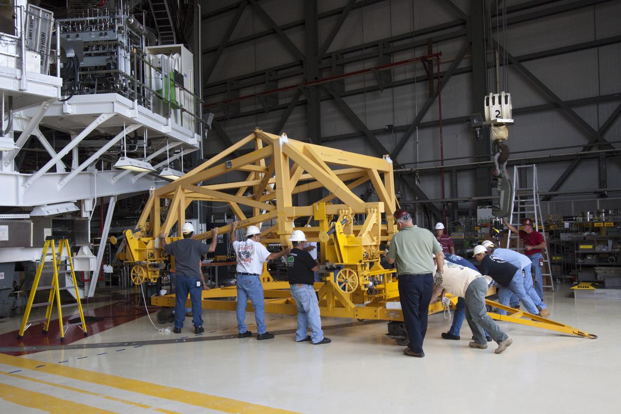CAPE CANAVERAL, Fla. – Inside Orbiter Processing Facility-2 at NASA’s Kennedy Space Center in Florida, technicians position support equipment around space shuttle Atlantis in preparation for removal of the left orbital maneuvering system (OMS) pod.   The work is part of the Space Shuttle Program’s transition and retirement processing of shuttle Atlantis. The OMS pods will be sent to White Sands Space Harbor in New Mexico where they will undergo a complete deservicing and cleaning and then be returned to Kennedy for reinstallation on Atlantis.  Atlantis is being prepared for display at the Kennedy Space Center Visitor Complex in Florida.  Photo credit: NASA_Jim Grossmann