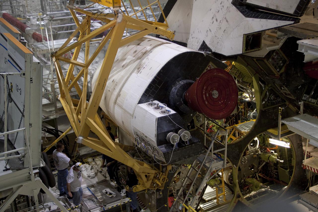 CAPE CANAVERAL, Fla. – Inside Orbiter Processing Facility-2 at NASA’s Kennedy Space Center in Florida, technicians monitor the progress as a large crane with support equipment lifts the left orbital maneuvering system (OMS) pod away from space shuttle Atlantis.   The work is part of the Space Shuttle Program’s transition and retirement processing of shuttle Atlantis. The OMS pods will be sent to White Sands Space Harbor in New Mexico where they will undergo a complete deservicing and cleaning and then be returned to Kennedy for reinstallation on Atlantis.  Atlantis is being prepared for display at the Kennedy Space Center Visitor Complex in Florida.  Photo credit: NASA_Jim Grossmann