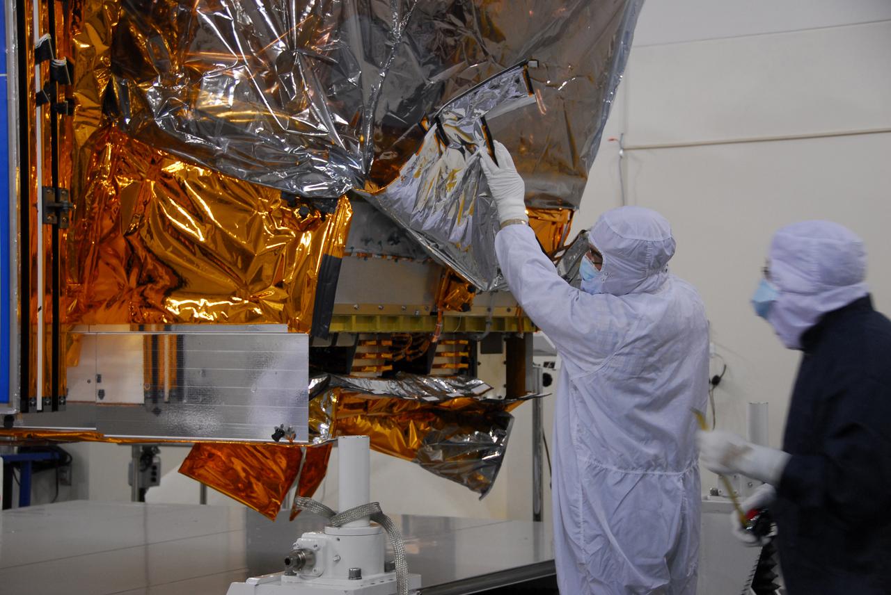 In a clean room inside the Astrotech Payload Processing Facility at Vandenberg Air Force Base in California, Ball Aerospace technicians prepare NASA’s National Polar-orbiting Operational Environmental Satellite System Preparatory Project (NPP) for testing. NPP represents a critical first step in building the next-generation of Earth-observing satellites. NPP will carry the first of the new sensors developed for this satellite fleet, now known as the Joint Polar Satellite System (JPSS), to be launched in 2016. NPP is the bridge between NASA's Earth Observing System (EOS) satellites and the forthcoming series of JPSS satellites. The mission will test key technologies and instruments for the JPSS missions. NPP is targeted to launch Oct. 28 from Space Launch Complex-2 aboard a United Launch Alliance Delta II rocket. For more information, visit http:__www.nasa.gov_NPP. Photo credit: NASA_Aaron Taubman, 30th Communications Squadron, VAFB