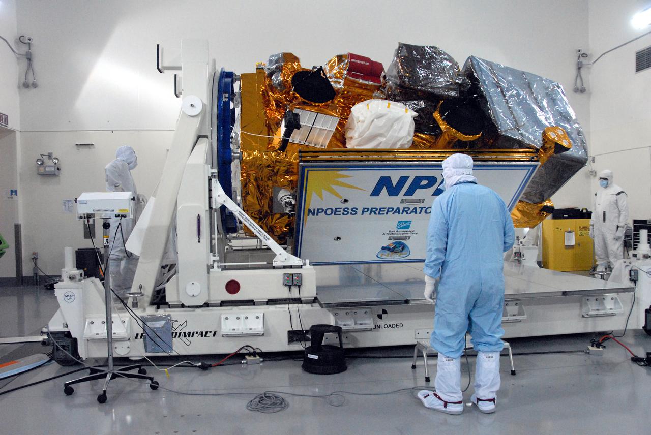 In a clean room inside the Astrotech Payload Processing Facility at Vandenberg Air Force Base in California, a Ball Aerospace technician closes out NASA’s National Polar-orbiting Operational Environmental Satellite System Preparatory Project (NPP) before preparing it for transport to the launch pad.      NPP represents a critical first step in building the next-generation of Earth-observing satellites. NPP will carry the first of the new sensors developed for this satellite fleet, now known as the Joint Polar Satellite System (JPSS), to be launched in 2016. NPP is the bridge between NASA's Earth Observing System (EOS) satellites and the forthcoming series of JPSS satellites. The mission will test key technologies and instruments for the JPSS missions. NPP is targeted to launch Oct. 28 from Space Launch Complex-2 aboard a United Launch Alliance Delta II rocket. For more information, visit http:__www.nasa.gov_NPP.  Photo credit: NASA_Dan Kokoska, VAFB