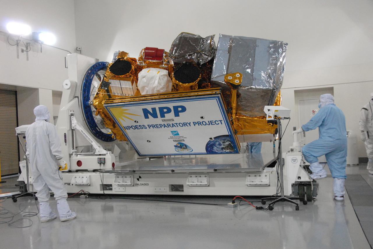 In a clean room inside the Astrotech Payload Processing Facility at Vandenberg Air Force Base in California, Ball Aerospace technicians close out NASA’s National Polar-orbiting Operational Environmental Satellite System Preparatory Project (NPP) before preparing it for transport to the launch pad.   NPP represents a critical first step in building the next-generation of Earth-observing satellites. NPP will carry the first of the new sensors developed for this satellite fleet, now known as the Joint Polar Satellite System (JPSS), to be launched in 2016. NPP is the bridge between NASA's Earth Observing System (EOS) satellites and the forthcoming series of JPSS satellites. The mission will test key technologies and instruments for the JPSS missions. NPP is targeted to launch Oct. 28 from Space Launch Complex-2 aboard a United Launch Alliance Delta II rocket. For more information, visit http:__www.nasa.gov_NPP.  Photo credit: NASA_Dan Kokoska, VAFB