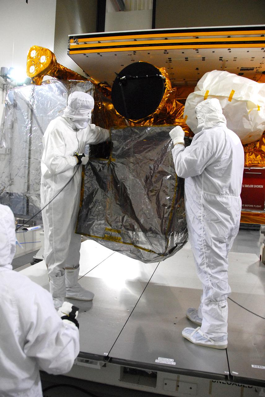In a clean room inside the Astrotech Payload Processing Facility at Vandenberg Air Force Base in California, Ball Aerospace technicians conduct a final cleaning and inspection of the Cross-track Infrared Sounder (CrIS) on NASA’s National Polar-orbiting Operational Environmental Satellite System Preparatory Project (NPP) spacecraft. NPP represents a critical first step in building the next-generation of Earth-observing satellites. NPP will carry the first of the new sensors developed for this satellite fleet, now known as the Joint Polar Satellite System (JPSS), to be launched in 2016. NPP is the bridge between NASA's Earth Observing System (EOS) satellites and the forthcoming series of JPSS satellites. The mission will test key technologies and instruments for the JPSS missions. NPP is targeted to launch Oct. 28 from Space Launch Complex-2 aboard a United Launch Alliance Delta II rocket. For more information, visit http:__www.nasa.gov_NPP. Photo credit: NASA_VAFB