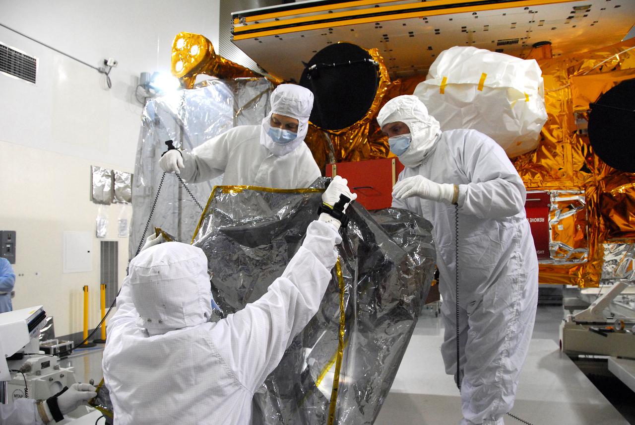 In a clean room inside the Astrotech Payload Processing Facility at Vandenberg Air Force Base in California, Ball Aerospace technicians conduct a final cleaning and inspection of the Cross-track Infrared Sounder (CrIS) on NASA’s National Polar-orbiting Operational Environmental Satellite System Preparatory Project (NPP) spacecraft.     NPP represents a critical first step in building the next-generation of Earth-observing satellites. NPP will carry the first of the new sensors developed for this satellite fleet, now known as the Joint Polar Satellite System (JPSS), to be launched in 2016. NPP is the bridge between NASA's Earth Observing System (EOS) satellites and the forthcoming series of JPSS satellites. The mission will test key technologies and instruments for the JPSS missions. NPP is targeted to launch Oct. 28 from Space Launch Complex-2 aboard a United Launch Alliance Delta II rocket. For more information, visit http:__www.nasa.gov_NPP.  Photo credit: NASA_VAFB