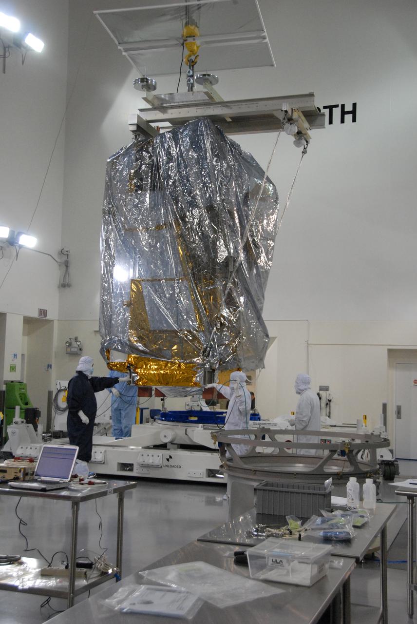 In a clean room inside the Astrotech Payload Processing Facility at Vandenberg Air Force Base in California, Ball Aerospace technicians prepare to attach NASA’s National Polar-orbiting Operational Environmental Satellite System Preparatory Project (NPP) spacecraft to a payload adapter. NPP represents a critical first step in building the next-generation of Earth-observing satellites. NPP will carry the first of the new sensors developed for this satellite fleet, now known as the Joint Polar Satellite System (JPSS), to be launched in 2016. NPP is the bridge between NASA's Earth Observing System (EOS) satellites and the forthcoming series of JPSS satellites. The mission will test key technologies and instruments for the JPSS missions. NPP is targeted to launch Oct. 28 from Space Launch Complex-2 aboard a United Launch Alliance Delta II rocket. For more information, visit http:__www.nasa.gov_NPP. Photo credit: NASA_Roy Allison, VAFB