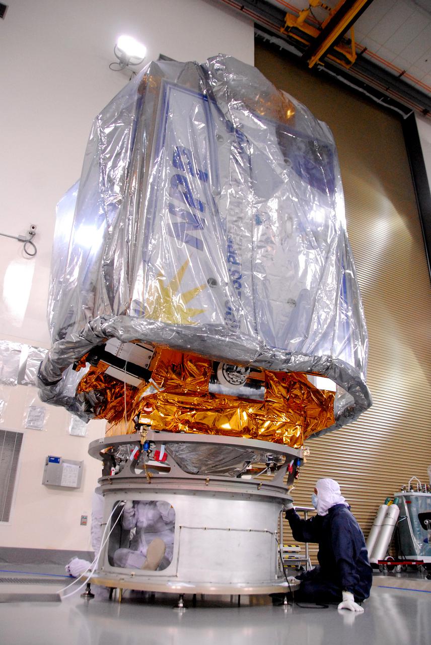 In a clean room inside the Astrotech Payload Processing Facility at Vandenberg Air Force Base in California, a Ball Aerospace technician NASA’s National Polar-orbiting Operational Environmental Satellite System Preparatory Project (NPP) spacecraft for its move to the launch pad.   NPP represents a critical first step in building the next-generation of Earth-observing satellites. NPP will carry the first of the new sensors developed for this satellite fleet, now known as the Joint Polar Satellite System (JPSS), to be launched in 2016. NPP is the bridge between NASA's Earth Observing System (EOS) satellites and the forthcoming series of JPSS satellites. The mission will test key technologies and instruments for the JPSS missions. NPP is targeted to launch Oct. 28 from Space Launch Complex-2 aboard a United Launch Alliance Delta II rocket. For more information, visit http:__www.nasa.gov_NPP.  Photo credit: NASA_VAFB