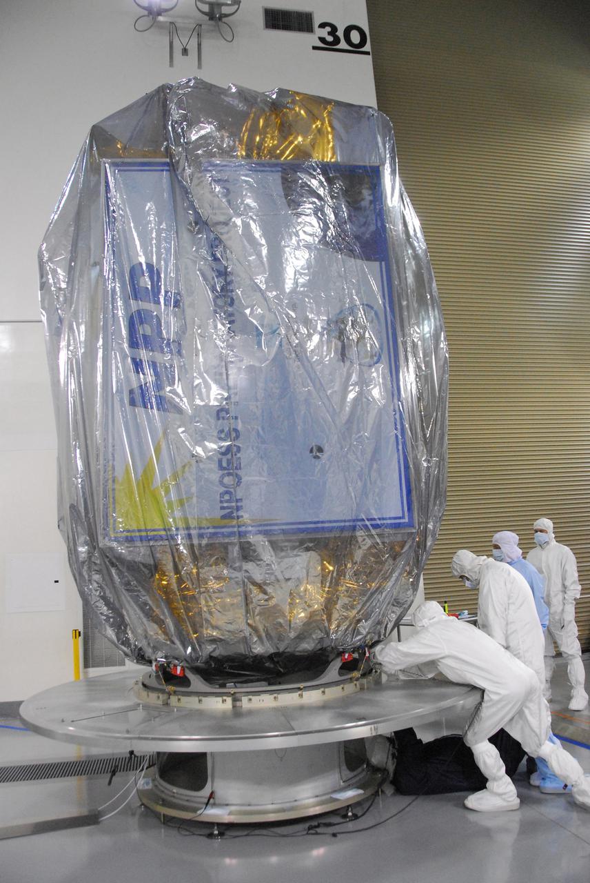 In a clean room inside the Astrotech Payload Processing Facility at Vandenberg Air Force Base in California, Ball Aerospace technicians NASA’s National Polar-orbiting Operational Environmental Satellite System Preparatory Project (NPP) spacecraft for its move to the launch pad. NPP represents a critical first step in building the next-generation of Earth-observing satellites. NPP will carry the first of the new sensors developed for this satellite fleet, now known as the Joint Polar Satellite System (JPSS), to be launched in 2016. NPP is the bridge between NASA's Earth Observing System (EOS) satellites and the forthcoming series of JPSS satellites. The mission will test key technologies and instruments for the JPSS missions. NPP is targeted to launch Oct. 28 from Space Launch Complex-2 aboard a United Launch Alliance Delta II rocket. For more information, visit http:__www.nasa.gov_NPP. Photo credit: NASA_VAFB