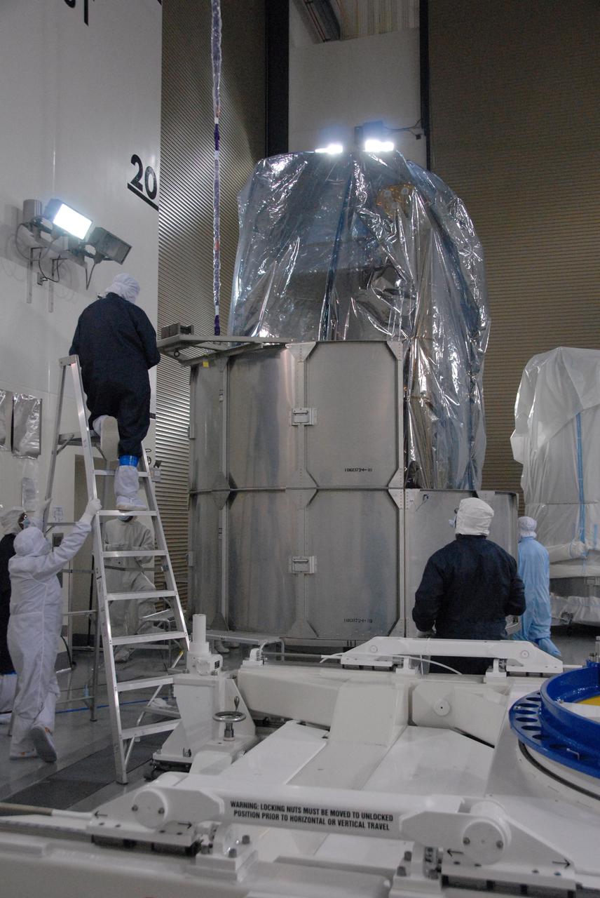 In a clean room inside the Astrotech Payload Processing Facility at Vandenberg Air Force Base in California, Ball Aerospace technicians install NASA’s National Polar-orbiting Operational Environmental Satellite System Preparatory Project (NPP) spacecraft in a payload transportation canister for its trip to the launch pad. NPP represents a critical first step in building the next-generation of Earth-observing satellites. NPP will carry the first of the new sensors developed for this satellite fleet, now known as the Joint Polar Satellite System (JPSS), to be launched in 2016. NPP is the bridge between NASA's Earth Observing System (EOS) satellites and the forthcoming series of JPSS satellites. The mission will test key technologies and instruments for the JPSS missions. NPP is targeted to launch Oct. 28 from Space Launch Complex-2 aboard a United Launch Alliance Delta II rocket. For more information, visit http:__www.nasa.gov_NPP. Photo credit: NASA_Roy Allison, VAFB