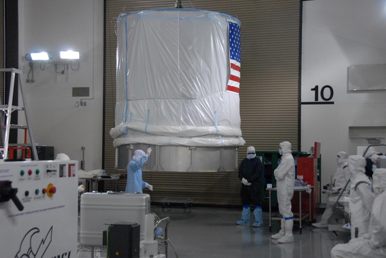 In a clean room inside the Astrotech Payload Processing Facility at Vandenberg Air Force Base in California, Ball Aerospace technicians work to install NASA’s National Polar-orbiting Operational Environmental Satellite System Preparatory Project (NPP) spacecraft in a payload transportation canister for its trip to the launch pad. NPP represents a critical first step in building the next-generation of Earth-observing satellites. NPP will carry the first of the new sensors developed for this satellite fleet, now known as the Joint Polar Satellite System (JPSS), to be launched in 2016. NPP is the bridge between NASA's Earth Observing System (EOS) satellites and the forthcoming series of JPSS satellites. The mission will test key technologies and instruments for the JPSS missions. NPP is targeted to launch Oct. 28 from Space Launch Complex-2 aboard a United Launch Alliance Delta II rocket. For more information, visit http:__www.nasa.gov_NPP. Photo credit: NASA_Roy Allison, VAFB