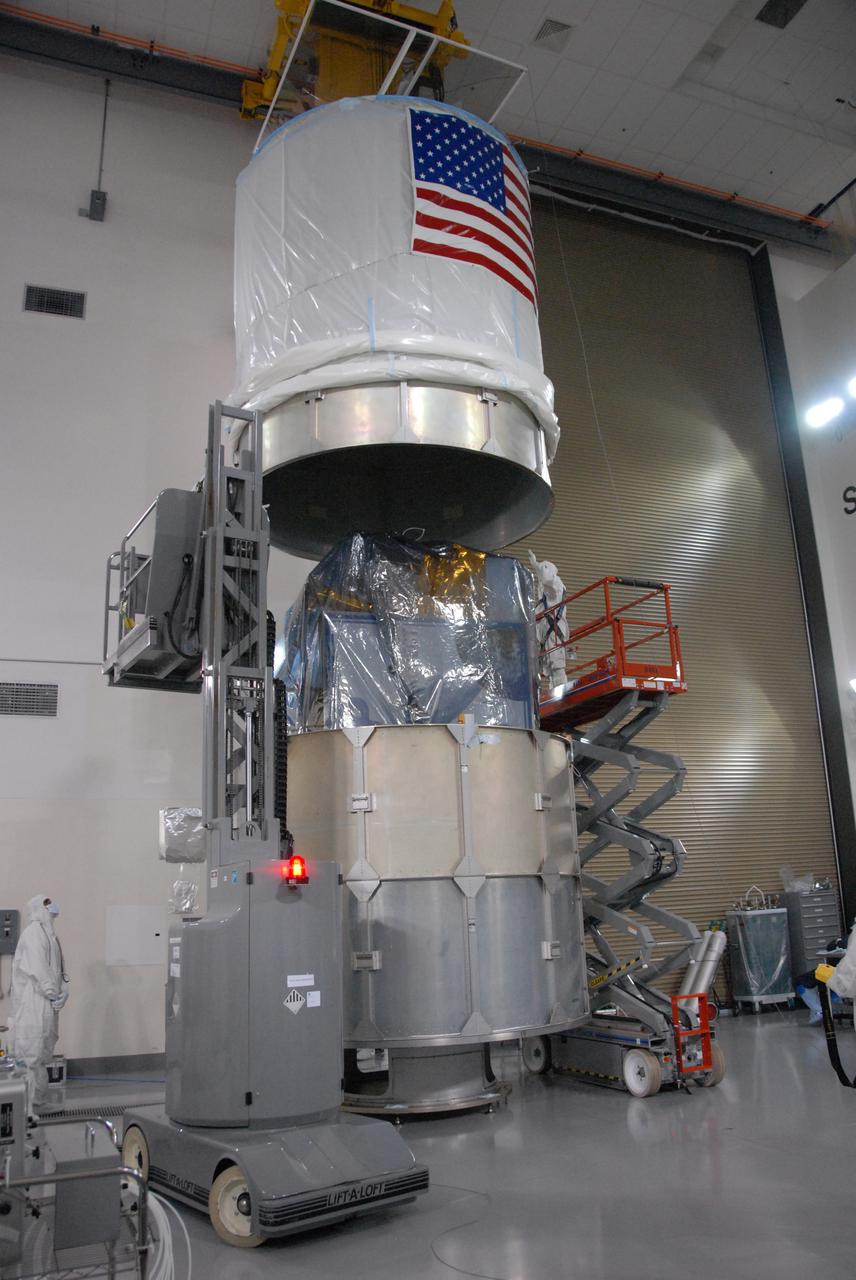 In a clean room inside the Astrotech Payload Processing Facility at Vandenberg Air Force Base in California, Ball Aerospace technicians finish installing NASA’s National Polar-orbiting Operational Environmental Satellite System Preparatory Project (NPP) spacecraft in a payload transportation canister in preparation for its trip to the launch pad. NPP represents a critical first step in building the next-generation of Earth-observing satellites. NPP will carry the first of the new sensors developed for this satellite fleet, now known as the Joint Polar Satellite System (JPSS), to be launched in 2016. NPP is the bridge between NASA's Earth Observing System (EOS) satellites and the forthcoming series of JPSS satellites. The mission will test key technologies and instruments for the JPSS missions. NPP is targeted to launch Oct. 28 from Space Launch Complex-2 aboard a United Launch Alliance Delta II rocket. For more information, visit http:__www.nasa.gov_NPP. Photo credit: NASA_Roy Allison, VAFB