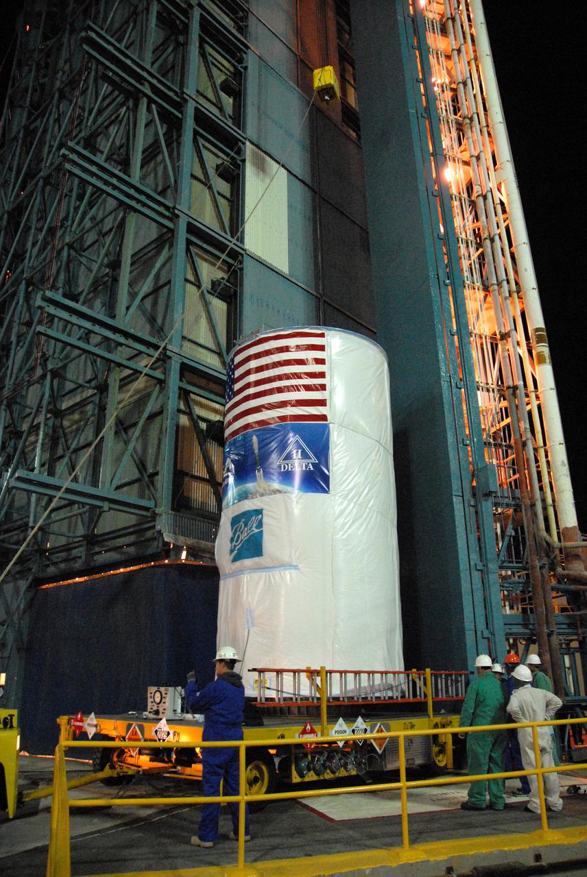 Workers at Vandenberg Air Force Base's Space Launch Complex-2 prepare to hoist NASA’s National Polar-orbiting Operational Environmental Satellite System Preparatory Project (NPP) spacecraft, which is tucked inside a protective payload transportation canister.   NPP represents a critical first step in building the next-generation of Earth-observing satellites. NPP will carry the first of the new sensors developed for this satellite fleet, now known as the Joint Polar Satellite System (JPSS), to be launched in 2016. NPP is the bridge between NASA's Earth Observing System (EOS) satellites and the forthcoming series of JPSS satellites. The mission will test key technologies and instruments for the JPSS missions. NPP is targeted to launch Oct. 28 from Space Launch Complex-2 aboard a United Launch Alliance Delta II rocket. For more information, visit http:__www.nasa.gov_NPP.  Photo credit: NASA_Mark P. Mackley, VAFB