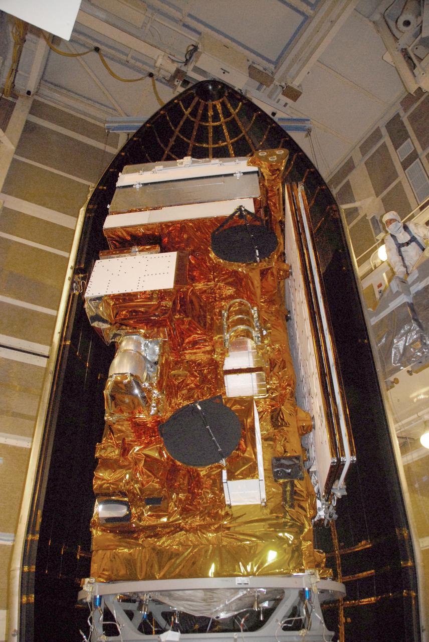 VANDENBERG AIR FORCE BASE, Calif. – At Vandenberg Air Force Base's Space Launch Complex-2 in California, technicians monitor the movement of a section of the clamshell-shaped Delta payload fairing as it encloses NASA’s National Polar-orbiting Operational Environmental Satellite System Preparatory Project (NPP) spacecraft. The fairing will protect the spacecraft from the impact of aerodynamic pressure and heating during ascent and will be jettisoned once the spacecraft is outside the Earth's atmosphere.  NPP represents a critical first step in building the next-generation of Earth-observing satellites. NPP will carry the first of the new sensors developed for this satellite fleet, now known as the Joint Polar Satellite System (JPSS) to be launched in 2016. NPP is the bridge between NASA's Earth Observing System (EOS) satellites and the forthcoming series of JPSS satellites. The mission will test key technologies and instruments for the JPSS missions. NPP is targeted to launch Oct. 28 from Space Launch Complex-2 aboard a United Launch Alliance Delta II rocket. For more information, visit http:__www.nasa.gov_NPP. Photo credit: NASA_Mark P. Mackley, VAFB