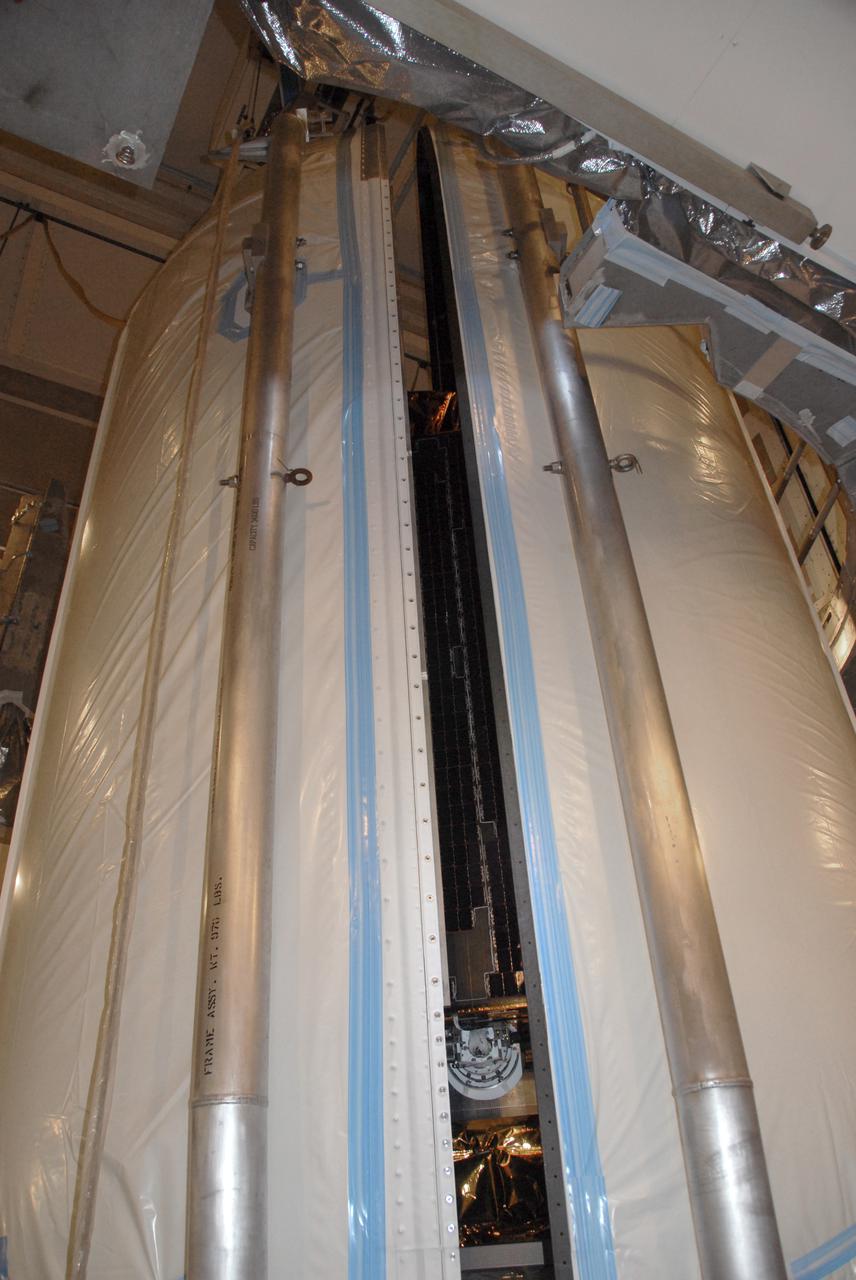 VANDENBERG AIR FORCE BASE, Calif. – At Vandenberg Air Force Base's Space Launch Complex-2 in California, encapsulation of NASA’s National Polar-orbiting Operational Environmental Satellite System Preparatory Project (NPP) spacecraft into the clamshell-shaped Delta payload fairing is almost complete. The fairing will protect the spacecraft from the impact of aerodynamic pressure and heating during ascent and will be jettisoned once the spacecraft is outside the Earth's atmosphere.  NPP represents a critical first step in building the next-generation of Earth-observing satellites. NPP will carry the first of the new sensors developed for this satellite fleet, now known as the Joint Polar Satellite System (JPSS) to be launched in 2016. NPP is the bridge between NASA's Earth Observing System (EOS) satellites and the forthcoming series of JPSS satellites. The mission will test key technologies and instruments for the JPSS missions. NPP is targeted to launch Oct. 28 from Space Launch Complex-2 aboard a United Launch Alliance Delta II rocket. For more information, visit http:__www.nasa.gov_NPP. Photo credit: NASA_Mark P. Mackley, VAFB