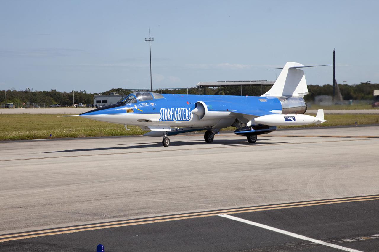 CAPE CANAVERAL, Fla. – Pilot Rick Svetkoff sits in the cockpit of a Starfighters, Inc. F-104 supersonic jet before conducting a high speed taxi test at the Shuttle Landing Facility (SLF) at NASA’s Kennedy Space Center in Florida. Hidden from the camera on the right side of the jet is the Star Lab suborbital launch vehicle developed by 4Frontiers Corporation.  4Frontiers is testing the Star Lab suborbital launch vehicle which has the potential to carry payloads into low earth orbit. Tests are being conducted to verify the aeronautical conditions of the Star Lab suborbital launch vehicle. This is the first of eight tests the launch vehicle will undergo. 4Frontiers Corporation is aiming for testing to be completed by early 2012, with commercial flights starting mid-2012. Starfighters, Inc. has signed a Space Act Agreement with NASA for the use of the SLF facilities at Kennedy Space Center. Photo credit: NASA_Gianni M. Woods