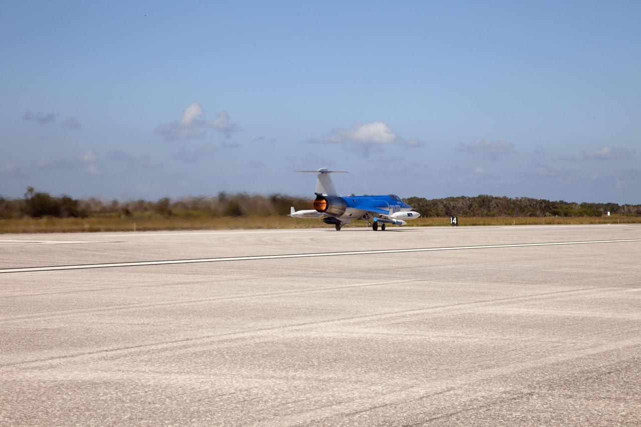 CAPE CANAVERAL, Fla. – On the runway at the Shuttle Landing Facility (SLF) at NASA’s Kennedy Space Center in Florida, a Starfighters, Inc. F-104 supersonic jet, piloted by Rick Svetkoff, picks up speed to conduct a high speed taxi test. The Star Lab suborbital launch vehicle developed by 4Frontiers Corporation is located on the right side of the jet.  4Frontiers is testing the Star Lab suborbital launch vehicle which has the potential to carry payloads into low earth orbit. Tests are being conducted to verify the aeronautical conditions of the Star Lab suborbital launch vehicle. This is the first of eight tests the launch vehicle will undergo. 4Frontiers Corporation is aiming for testing to be completed by early 2012, with commercial flights starting mid-2012. Starfighters, Inc. has signed a Space Act Agreement with NASA for the use of the SLF facilities at Kennedy Space Center. Photo credit: NASA_Gianni M. Woods