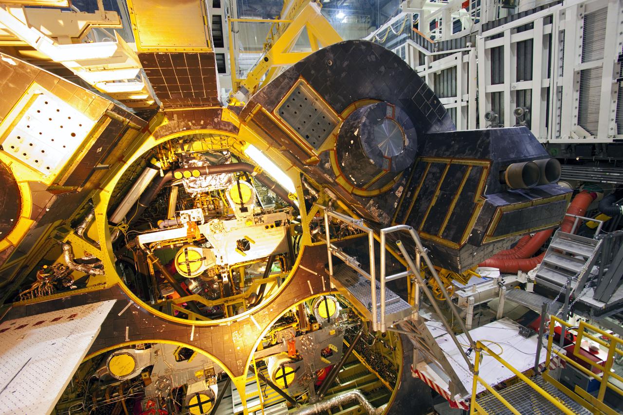 CAPE CANAVERAL, Fla. – Inside Orbiter Processing Facility-1 at NASA’s Kennedy Space Center in Florida, the right orbital maneuvering system (OMS) pod is being installed on space shuttle Discovery.  The OMS pods were returned from White Sands Space Harbor in New Mexico where they underwent a complete deservicing and cleaning. The work is part of the Space Shuttle Program’s transition and retirement processing of shuttle Discovery. Discovery is being prepared for display at Smithsonian’s National Air and Space Museum, Steven F. Udvar-Hazy Center in Chantilly, Va. For more information, visit http:__www.nasa.gov_shuttle.  Photo credit: NASA_Jim Grossmann