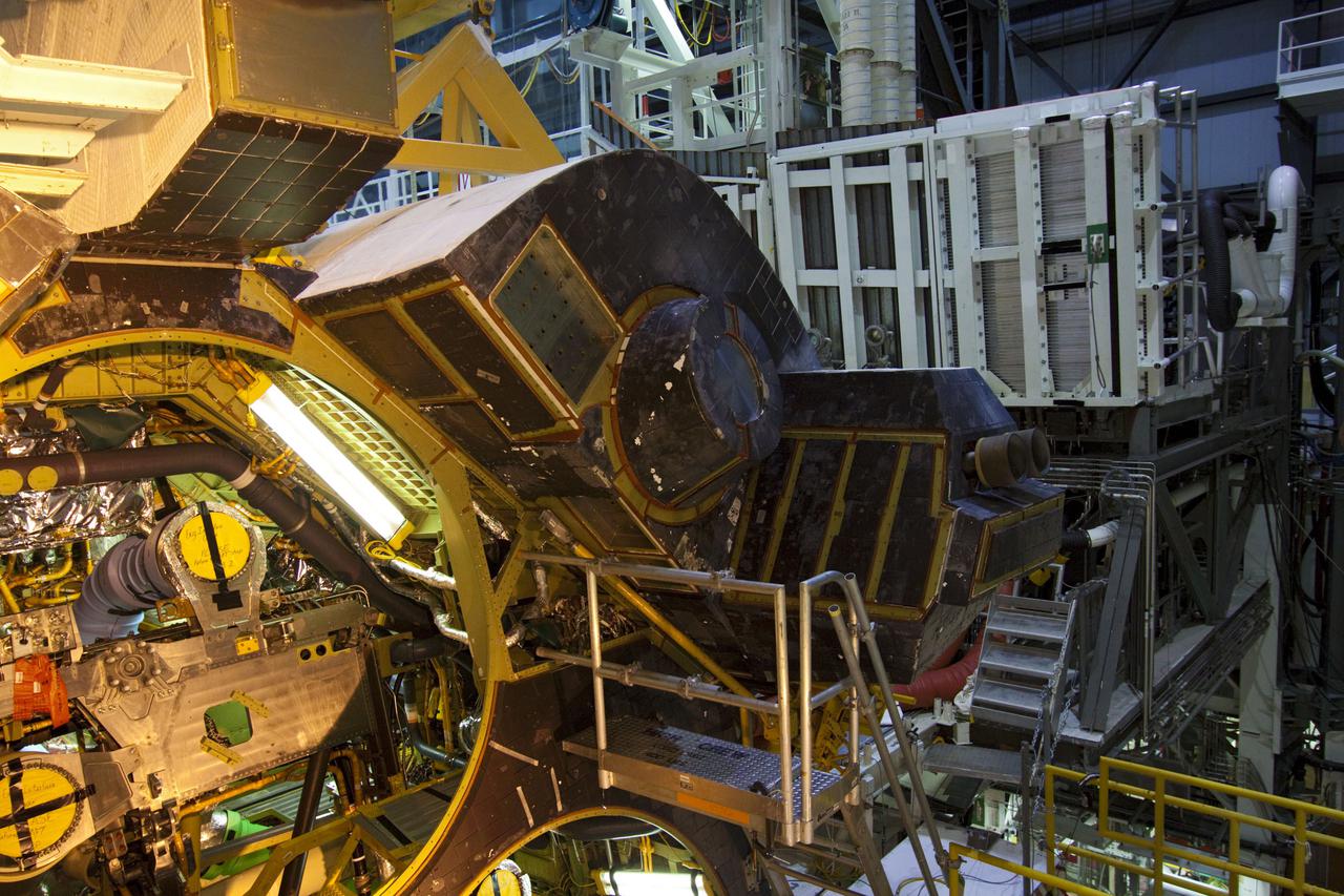 CAPE CANAVERAL, Fla. – Inside Orbiter Processing Facility-1 at NASA’s Kennedy Space Center in Florida, the right orbital maneuvering system (OMS) pod is being installed on space shuttle Discovery.  The OMS pods were returned from White Sands Space Harbor in New Mexico where they underwent a complete deservicing and cleaning. The work is part of the Space Shuttle Program’s transition and retirement processing of shuttle Discovery. Discovery is being prepared for display at Smithsonian’s National Air and Space Museum, Steven F. Udvar-Hazy Center in Chantilly, Va. For more information, visit http:__www.nasa.gov_shuttle.  Photo credit: NASA_Jim Grossmann