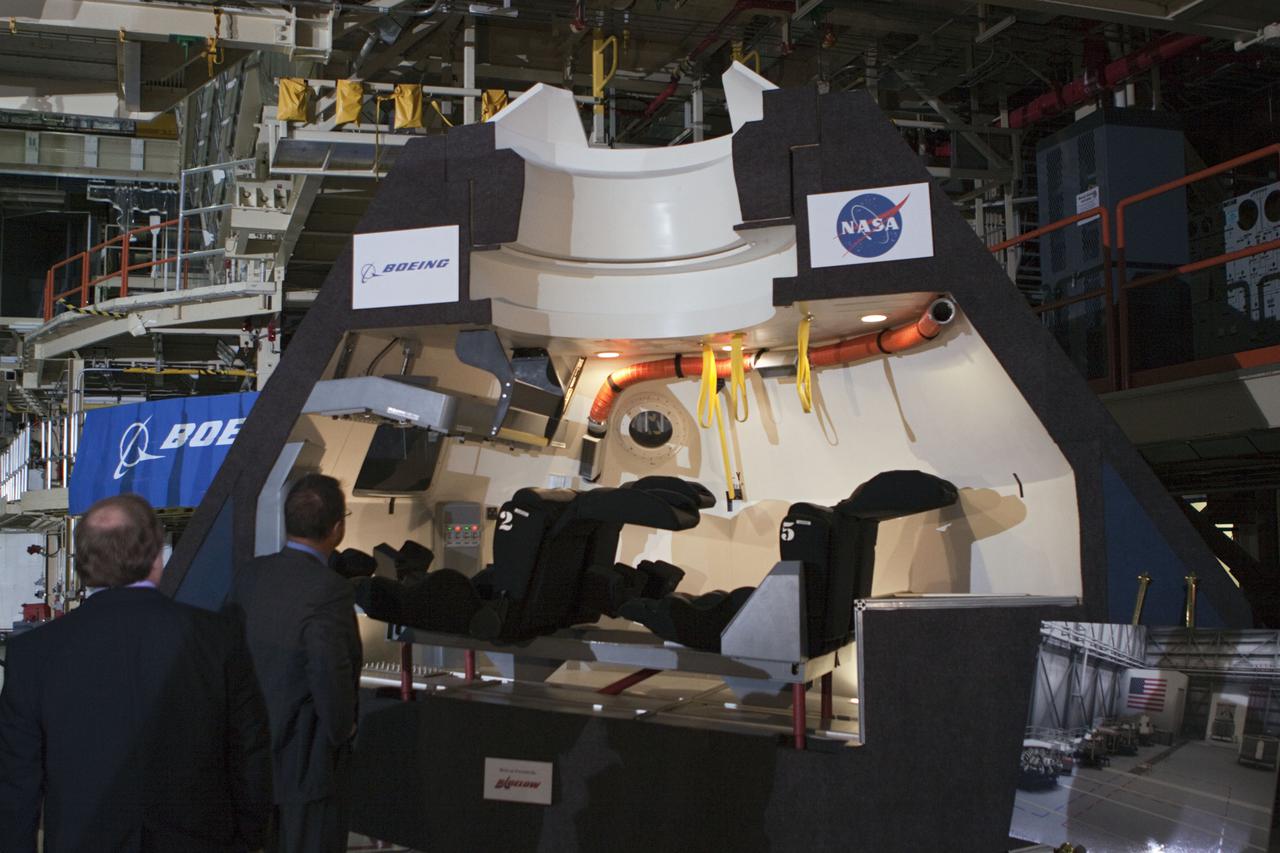 CAPE CANAVERAL, Fla. – In the Orbiter Processing Facility-3 (OPF-3) at NASA’s Kennedy Space Center in Florida, guests view a full-scale mockup of The Boeing Company’s CST-100 spacecraft at the ceremony announcing the signing of an innovative agreement between NASA and Space Florida.  NASA announced a partnership with Space Florida to occupy, use and modify Kennedy Space Center's Orbiter Processing Facility-3 (OPF-3), the Space Shuttle Main Engine Processing Facility and Processing Control Center. Space Florida has an agreement for use of the OPF-3 with the Boeing Company to manufacture and test the company's Crew Space Transportation (CST-100) spacecraft. The 15-year use permit deal is the latest step Kennedy is making as the center transitions from a historically government-only launch complex to a multi-user spaceport. For more information, visit http:__www.nasa.gov_exploration_commercial_index.html. Photo credit: NASA_Kim Shiflett