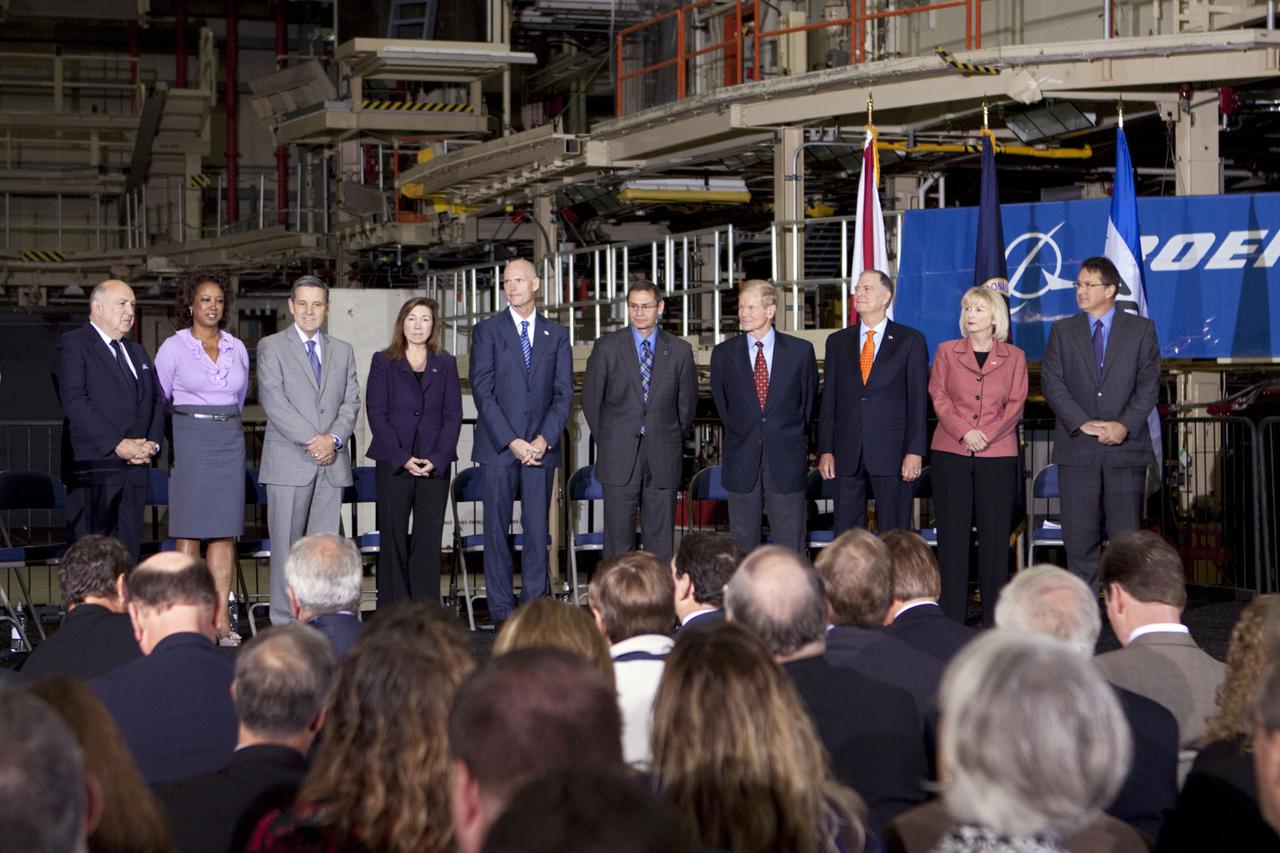 CAPE CANAVERAL, Fla. – In the Orbiter Processing Facility-3 (OPF-3) at NASA’s Kennedy Space Center in Florida, officials pose for a portrait proceeding the announcement of the signing of an innovative agreement between NASA and Space Florida. From left are, Frank DiBello, president of Space Florida, Florida Lt. Gov. Jennifer Carroll, chairwoman of Space Florida, Robert Cabana, Kennedy Space Center director, Lori Garver, NASA’s deputy administrator, Florida Gov. Rick Scott, John Elbon, vice president and general manager of Boeing's Space Exploration, Sen. Bill Nelson of Florida, Florida Congressman Bill Posey, Florida Representative Sandy Adams, and John Mulholland, vice president and program manager of Boeing's Commercial Crew Programs.  NASA announced a partnership with Space Florida to occupy, use and modify Kennedy Space Center's Orbiter Processing Facility-3 (OPF-3), the Space Shuttle Main Engine Processing Facility and Processing Control Center. Space Florida has an agreement for use of the OPF-3 with the Boeing Company to manufacture and test the company's Crew Space Transportation (CST-100) spacecraft. The 15-year use permit deal is the latest step Kennedy is making as the center transitions from a historically government-only launch complex to a multi-user spaceport. For more information, visit http:__www.nasa.gov_exploration_commercial_index.html. Photo credit: NASA_Kim Shiflett