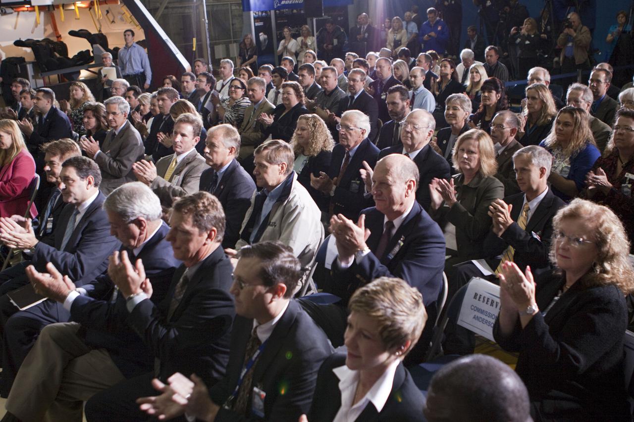 CAPE CANAVERAL, Fla. – In the Orbiter Processing Facility-3 (OPF-3) at NASA’s Kennedy Space Center in Florida, guests react during the ceremony announcing the signing of an innovative agreement between NASA and Space Florida.  NASA announced a partnership with Space Florida to occupy, use and modify Kennedy Space Center's Orbiter Processing Facility-3 (OPF-3), the Space Shuttle Main Engine Processing Facility and Processing Control Center. Space Florida has an agreement for use of the OPF-3 with the Boeing Company to manufacture and test the company's Crew Space Transportation (CST-100) spacecraft. The 15-year use permit deal is the latest step Kennedy is making as the center transitions from a historically government-only launch complex to a multi-user spaceport. For more information, visit http:__www.nasa.gov_exploration_commercial_index.html. Photo credit: NASA_Kim Shiflett