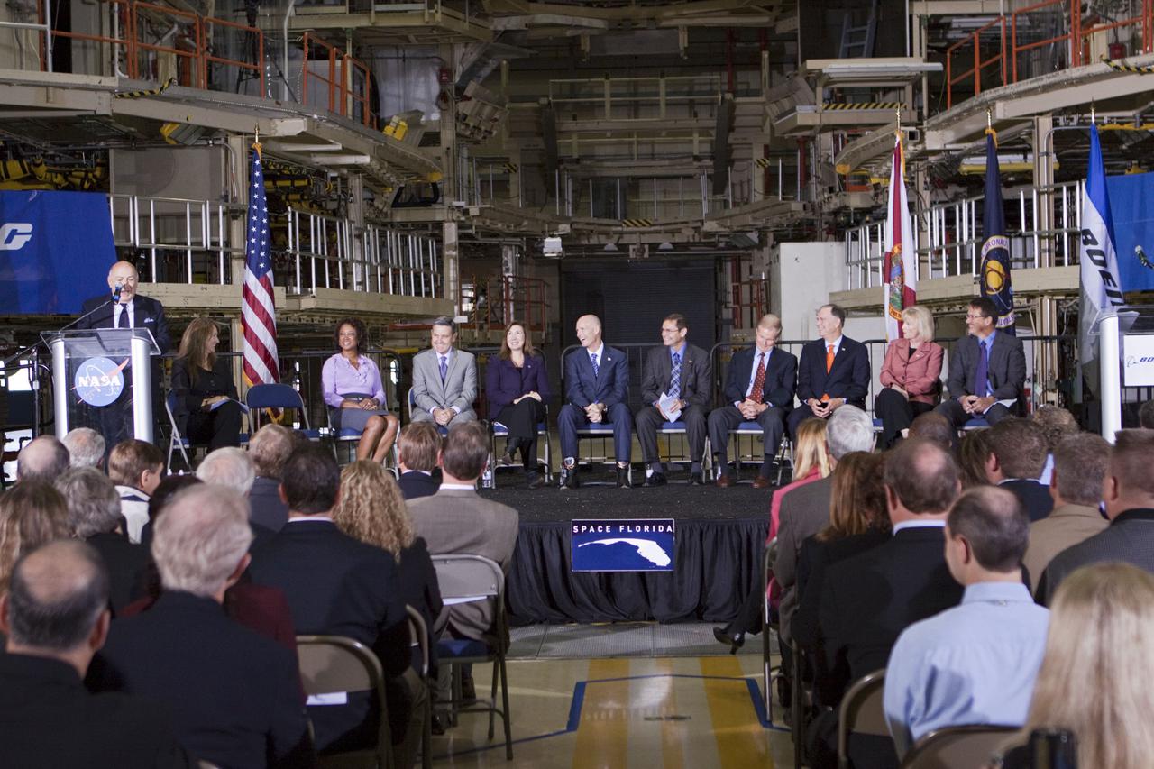 CAPE CANAVERAL, Fla. – In the Orbiter Processing Facility-3 (OPF-3) at NASA’s Kennedy Space Center in Florida, Frank DiBello, president of Space Florida, speaks to the audience after announcing the signing of an innovative agreement between NASA and Space Florida.  From his left are, Joyce Riquelme, manager of Kennedy's Center Planning and Development Office, Florida Lt. Gov. Jennifer Carroll, chairwoman of Space Florida, Robert Cabana, Kennedy Space Center director, Lori Garver, NASA’s deputy administrator, Florida Gov. Rick Scott, John Elbon, vice president and general manager of Boeing's Space Exploration, Sen. Bill Nelson of Florida, Florida Congressman Bill Posey, Florida Representative Sandy Adams, and John Mulholland, vice president and program manager of Boeing's Commercial Crew Programs.  NASA announced a partnership with Space Florida to occupy, use and modify Kennedy Space Center's Orbiter Processing Facility-3 (OPF-3), the Space Shuttle Main Engine Processing Facility and Processing Control Center. Space Florida has an agreement for use of the OPF-3 with the Boeing Company to manufacture and test the company's Crew Space Transportation (CST-100) spacecraft. The 15-year use permit deal is the latest step Kennedy is making as the center transitions from a historically government-only launch complex to a multi-user spaceport. For more information, visit http:__www.nasa.gov_exploration_commercial_index.html. Photo credit: NASA_Kim Shiflett