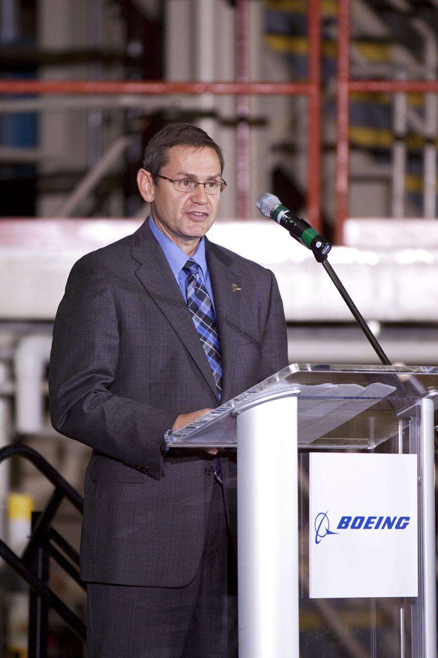 CAPE CANAVERAL, Fla. – In the Orbiter Processing Facility-3 (OPF-3) at NASA’s Kennedy Space Center in Florida, John Elbon, vice president and general manager of Boeing's Space Exploration, speaks to the audience during the ceremony announcing the signing of an innovative agreement between NASA and Space Florida.  NASA announced a partnership with Space Florida to occupy, use and modify Kennedy Space Center's Orbiter Processing Facility-3 (OPF-3), the Space Shuttle Main Engine Processing Facility and Processing Control Center. Space Florida has an agreement for use of the OPF-3 with the Boeing Company to manufacture and test the company's Crew Space Transportation (CST-100) spacecraft. The 15-year use permit deal is the latest step Kennedy is making as the center transitions from a historically government-only launch complex to a multi-user spaceport. For more information, visit http:__www.nasa.gov_exploration_commercial_index.html. Photo credit: NASA_Kim Shiflett