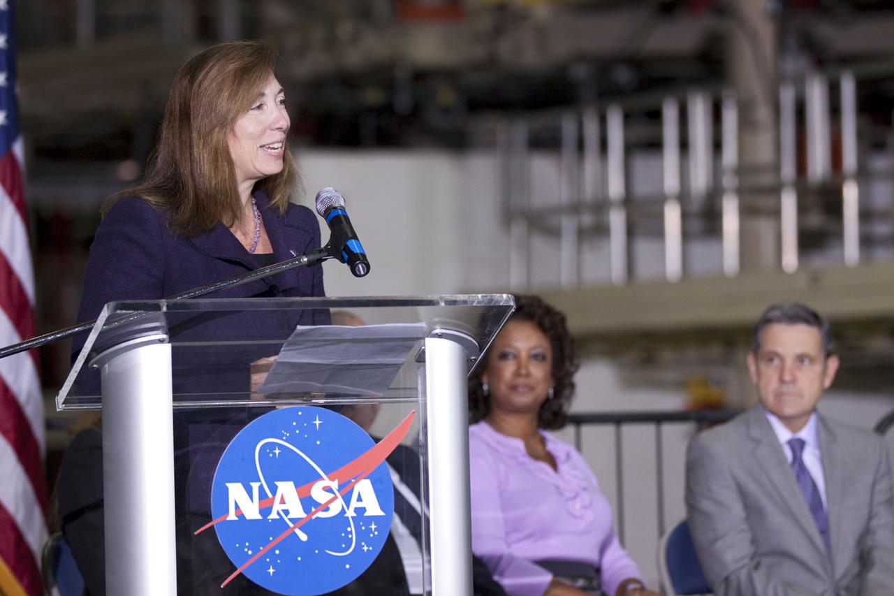 CAPE CANAVERAL, Fla. – In the Orbiter Processing Facility-3 (OPF-3) at NASA’s Kennedy Space Center in Florida, Lori Garver, NASA’s deputy administrator, speaks to the audience during the ceremony announcing the signing of an innovative agreement between NASA and Space Florida. Seated to her left are, Florida Lt. Gov. Jennifer Carroll, chairwoman of Space Florida and Robert Cabana, Kennedy Space Center director. NASA announced a partnership with Space Florida to occupy, use and modify Kennedy Space Center's Orbiter Processing Facility-3 (OPF-3), the Space Shuttle Main Engine Processing Facility and Processing Control Center. Space Florida has an agreement for use of the OPF-3 with the Boeing Company to manufacture and test the company's Crew Space Transportation (CST-100) spacecraft. The 15-year use permit deal is the latest step Kennedy is making as the center transitions from a historically government-only launch complex to a multi-user spaceport. For more information, visit http:__www.nasa.gov_exploration_commercial_index.html. Photo credit: NASA_Kim Shiflett