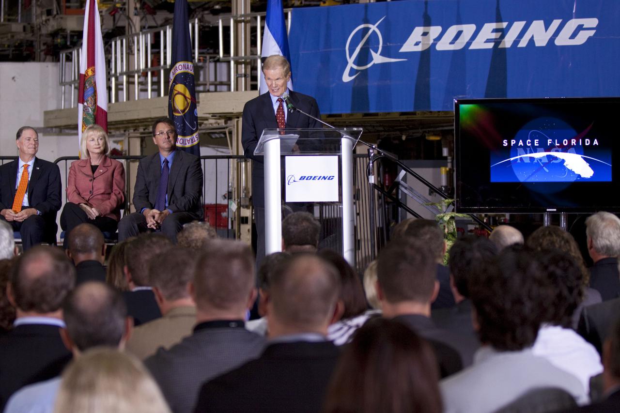 CAPE CANAVERAL, Fla. – In the Orbiter Processing Facility-3 (OPF-3) at NASA’s Kennedy Space Center in Florida, Sen. Bill Nelson of Florida speaks to the audience during the ceremony announcing the signing of an innovative agreement between NASA and Space Florida. Seated to his right are, Florida Congressman Bill Posey, Florida Representative Sandy Adams, and John Mulholland, vice president and program manager of Boeing's Commercial Crew Programs.  NASA announced a partnership with Space Florida to occupy, use and modify Kennedy Space Center's Orbiter Processing Facility-3 (OPF-3), the Space Shuttle Main Engine Processing Facility and Processing Control Center. Space Florida has an agreement for use of the OPF-3 with the Boeing Company to manufacture and test the company's Crew Space Transportation (CST-100) spacecraft. The 15-year use permit deal is the latest step Kennedy is making as the center transitions from a historically government-only launch complex to a multi-user spaceport. For more information, visit http:__www.nasa.gov_exploration_commercial_index.html. Photo credit: NASA_Kim Shiflett