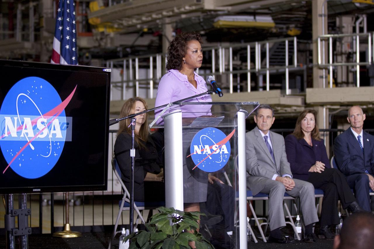 CAPE CANAVERAL, Fla. – In the Orbiter Processing Facility-3 (OPF-3) at NASA’s Kennedy Space Center in Florida, Florida Lt. Gov. Jennifer Carroll, chairwoman of Space Florida, speaks to the audience during the ceremony announcing the signing of an innovative agreement between NASA and Space Florida. Seated from left are Joyce Riquelme, manager of Kennedy's Center Planning and Development Office, Robert Cabana, Kennedy Space Center director, Lori Garver, NASA’s deputy administrator, and Florida Gov. Rick Scott. NASA announced a partnership with Space Florida to occupy, use and modify Kennedy Space Center's Orbiter Processing Facility-3 (OPF-3), the Space Shuttle Main Engine Processing Facility and Processing Control Center. Space Florida has an agreement for use of the OPF-3 with the Boeing Company to manufacture and test the company's Crew Space Transportation (CST-100) spacecraft. The 15-year use permit deal is the latest step Kennedy is making as the center transitions from a historically government-only launch complex to a multi-user spaceport. For more information, visit http:__www.nasa.gov_exploration_commercial_index.html. Photo credit: NASA_Kim Shiflett