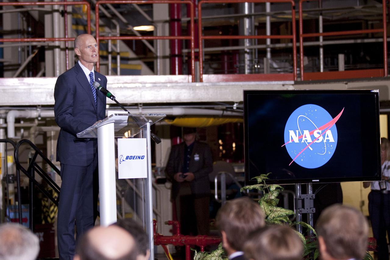 CAPE CANAVERAL, Fla. – In the Orbiter Processing Facility-3 (OPF-3) at NASA’s Kennedy Space Center in Florida, Florida Gov. Rick Scott speaks to the audience during the ceremony announcing the signing of an innovative agreement between NASA and Space Florida.  NASA announced a partnership with Space Florida to occupy, use and modify Kennedy Space Center's Orbiter Processing Facility-3 (OPF-3), the Space Shuttle Main Engine Processing Facility and Processing Control Center. Space Florida has an agreement for use of the OPF-3 with the Boeing Company to manufacture and test the company's Crew Space Transportation (CST-100) spacecraft. The 15-year use permit deal is the latest step Kennedy is making as the center transitions from a historically government-only launch complex to a multi-user spaceport. For more information, visit http:__www.nasa.gov_exploration_commercial_index.html. Photo credit: NASA_Kim Shiflett