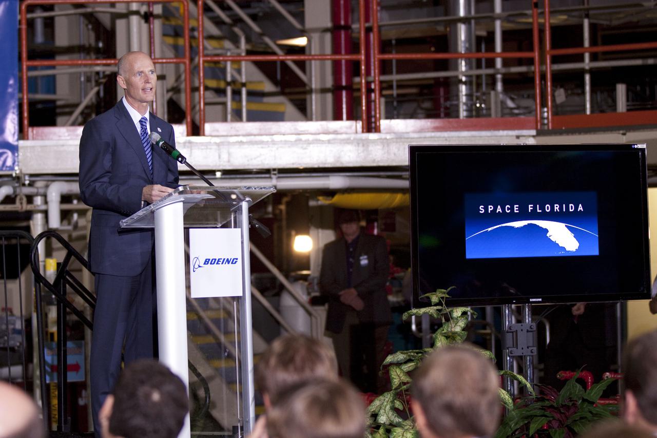 CAPE CANAVERAL, Fla. – In the Orbiter Processing Facility-3 (OPF-3) at NASA’s Kennedy Space Center in Florida, Florida Gov. Rick Scott speaks to the audience during the ceremony announcing the signing of an innovative agreement between NASA and Space Florida.  NASA announced a partnership with Space Florida to occupy, use and modify Kennedy Space Center's Orbiter Processing Facility-3 (OPF-3), the Space Shuttle Main Engine Processing Facility and Processing Control Center. Space Florida has an agreement for use of the OPF-3 with the Boeing Company to manufacture and test the company's Crew Space Transportation (CST-100) spacecraft. The 15-year use permit deal is the latest step Kennedy is making as the center transitions from a historically government-only launch complex to a multi-user spaceport. For more information, visit http:__www.nasa.gov_exploration_commercial_index.html. Photo credit: NASA_Kim Shiflett