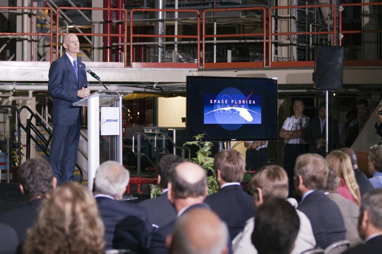 CAPE CANAVERAL, Fla. – In the Orbiter Processing Facility-3 (OPF-3) at NASA’s Kennedy Space Center in Florida, Florida Gov. Rick Scott speaks to the audience during the ceremony announcing the signing of an innovative agreement between NASA and Space Florida.  NASA announced a partnership with Space Florida to occupy, use and modify Kennedy Space Center's Orbiter Processing Facility-3 (OPF-3), the Space Shuttle Main Engine Processing Facility and Processing Control Center. Space Florida has an agreement for use of the OPF-3 with the Boeing Company to manufacture and test the company's Crew Space Transportation (CST-100) spacecraft. The 15-year use permit deal is the latest step Kennedy is making as the center transitions from a historically government-only launch complex to a multi-user spaceport. For more information, visit http:__www.nasa.gov_exploration_commercial_index.html. Photo credit: NASA_Kim Shiflett