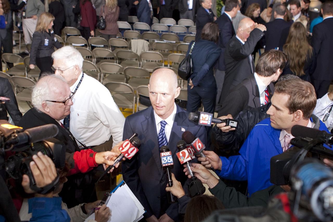 CAPE CANAVERAL, Fla. – In the Orbiter Processing Facility-3 (OPF-3) at NASA’s Kennedy Space Center in Florida, Florida Gov. Rick Scott speaks to the media following the ceremony which announced the signing of an innovative agreement between NASA and Space Florida.  NASA announced a partnership with Space Florida to occupy, use and modify Kennedy Space Center's Orbiter Processing Facility-3 (OPF-3), the Space Shuttle Main Engine Processing Facility and Processing Control Center. Space Florida has an agreement for use of the OPF-3 with the Boeing Company to manufacture and test the company's Crew Space Transportation (CST-100) spacecraft. The 15-year use permit deal is the latest step Kennedy is making as the center transitions from a historically government-only launch complex to a multi-user spaceport. For more information, visit http:__www.nasa.gov_exploration_commercial_index.html. Photo credit: NASA_Kim Shiflett