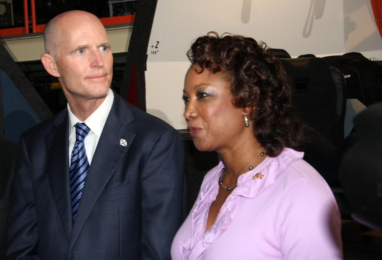 CAPE CANAVERAL, Fla. – In the Orbiter Processing Facility-3 (OPF-3) at NASA’s Kennedy Space Center in Florida, from right, Florida Lt. Gov. Jennifer Carroll, chairwoman of Space Florida and Florida Gov. Rick Scott, stand before a full-scale mockup of The Boeing Company’s CST-100 spacecraft after the ceremony which announced the signing of an innovative agreement between NASA and Space Florida.  NASA announced a partnership with Space Florida to occupy, use and modify Kennedy Space Center's Orbiter Processing Facility-3 (OPF-3), the Space Shuttle Main Engine Processing Facility and Processing Control Center. Space Florida has an agreement for use of the OPF-3 with the Boeing Company to manufacture and test the company's Crew Space Transportation (CST-100) spacecraft. The 15-year use permit deal is the latest step Kennedy is making as the center transitions from a historically government-only launch complex to a multi-user spaceport. For more information, visit http:__www.nasa.gov_exploration_commercial_index.html. Photo credit: NASA_Ken Thornsley