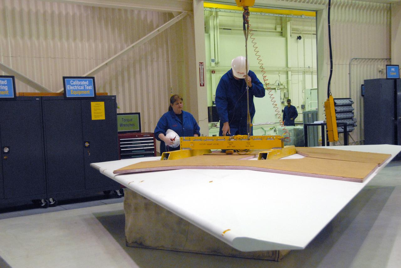 VANDENBERG AIR FORCE BASE, Calif. -- In a processing facility at Vandenberg Air Force Base in California, technicians prepare the wing for final installation on the Pegasus XL launch vehicle. The Orbital Sciences Corp. Pegasus rocket will launch the Nuclear Spectroscopic Telescope Array (NuSTAR) into space.   After the rocket and spacecraft are processed at Vandenberg, they will be flown on the Orbital Sciences’ L-1011 carrier aircraft to the Ronald Reagan Ballistic Missile Defense Test Site at the Pacific Ocean’s Kwajalein Atoll for launch. The high-energy x-ray telescope will conduct a census for black holes, map radioactive material in young supernovae remnants, and study the origins of cosmic rays and the extreme physics around collapsed stars. For more information, visit science.nasa.gov_missions_nustar_.  Photo credit: NASA_Randy Beaudoin, VAFB